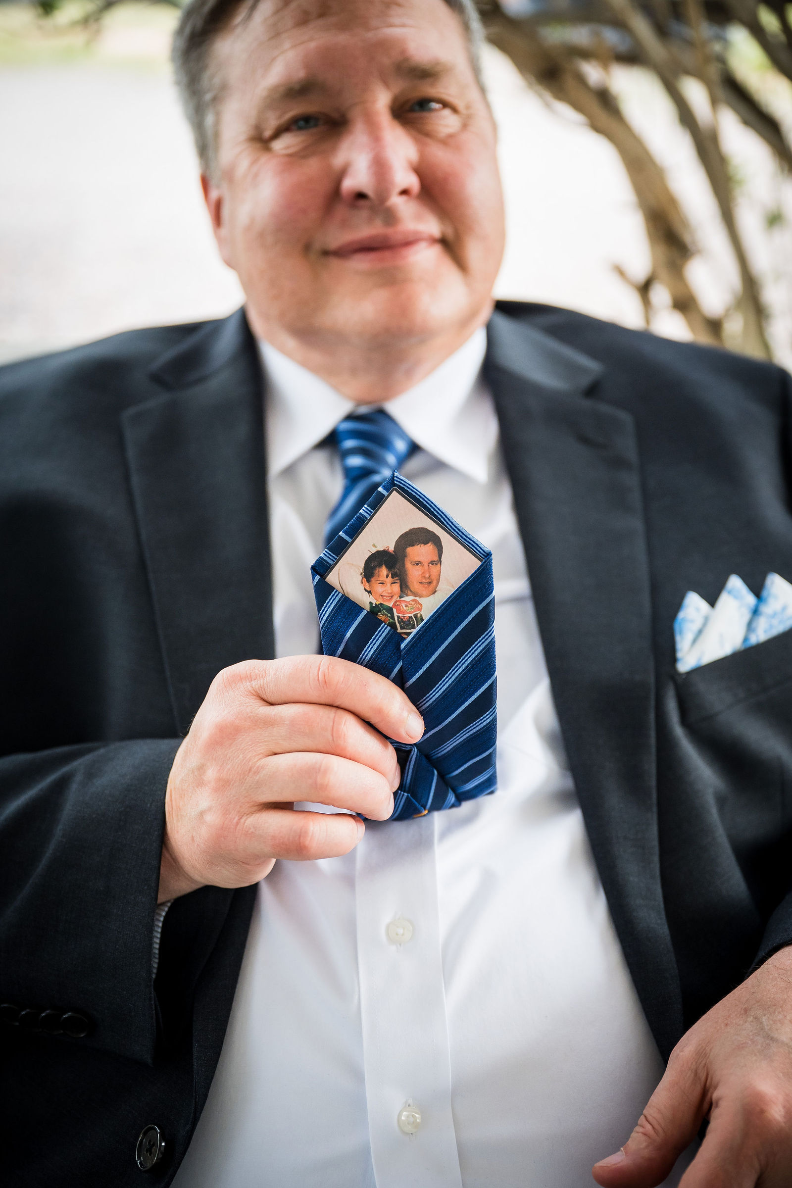 Father of the bride with a memorial photograph tucked inside his jacket