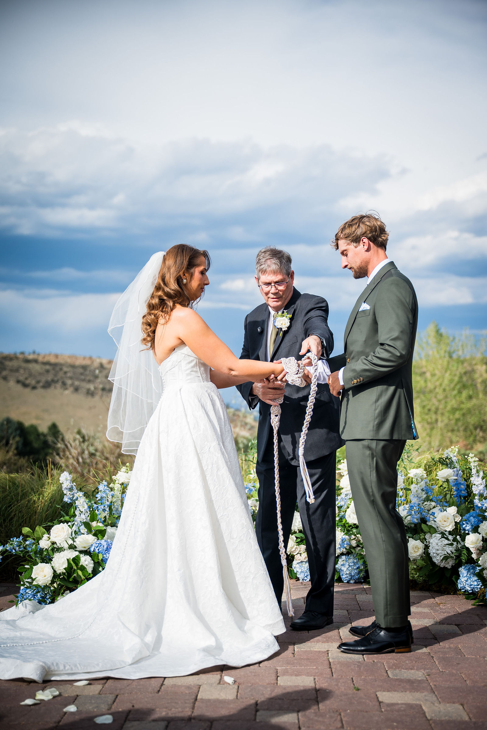 Couple tying a love knot during their ceremony at the Manor House