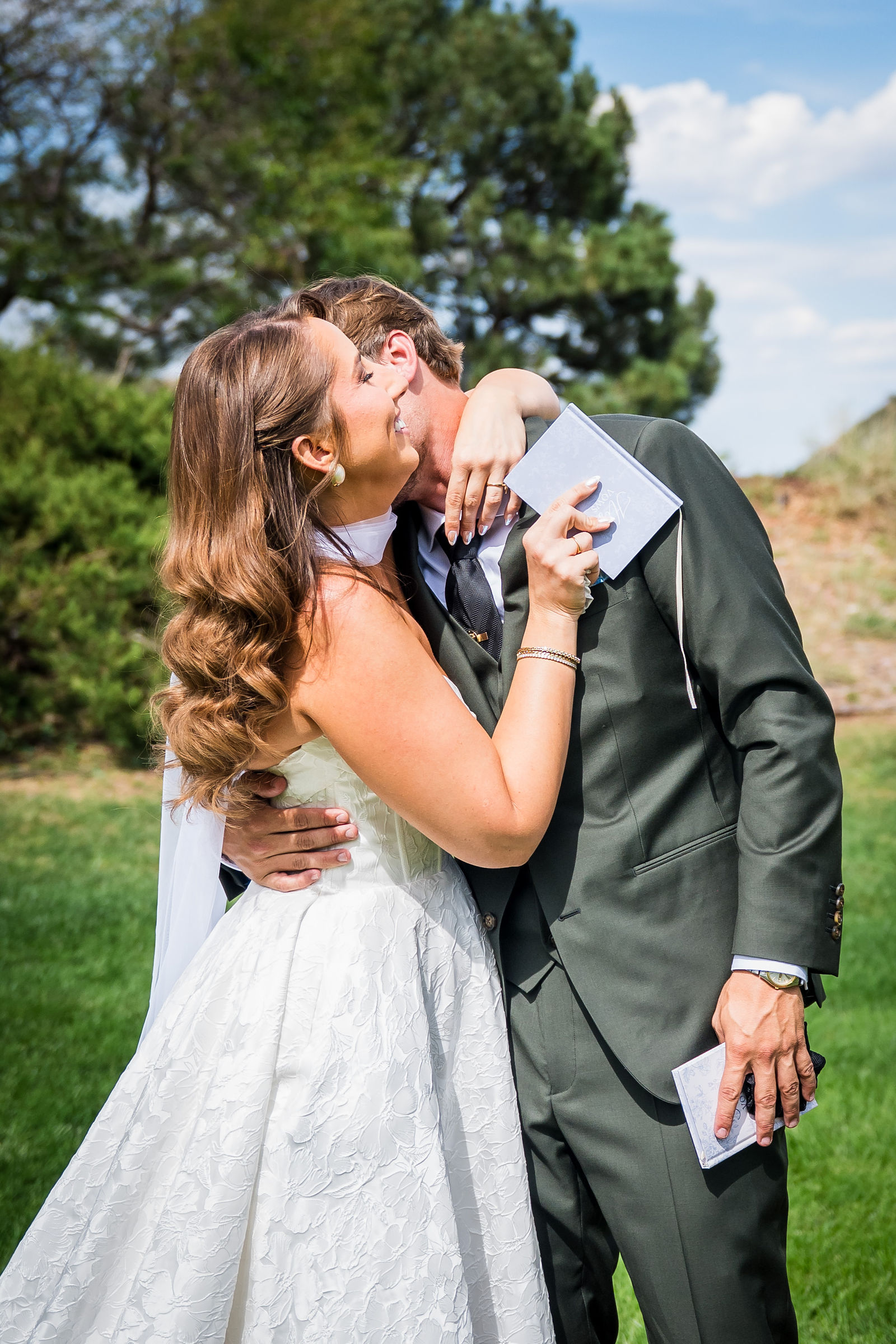 Bride and groom kissing after reading their private vows
