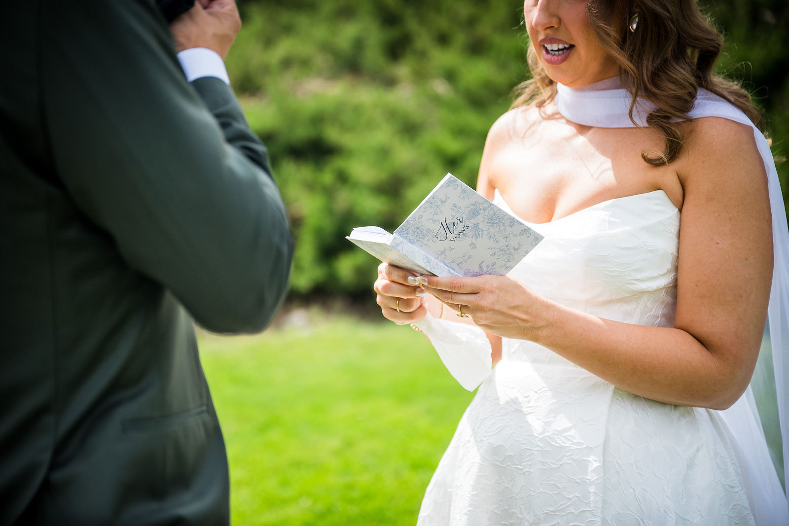 Groom reading his private vows aloud to his bride before the ceremony