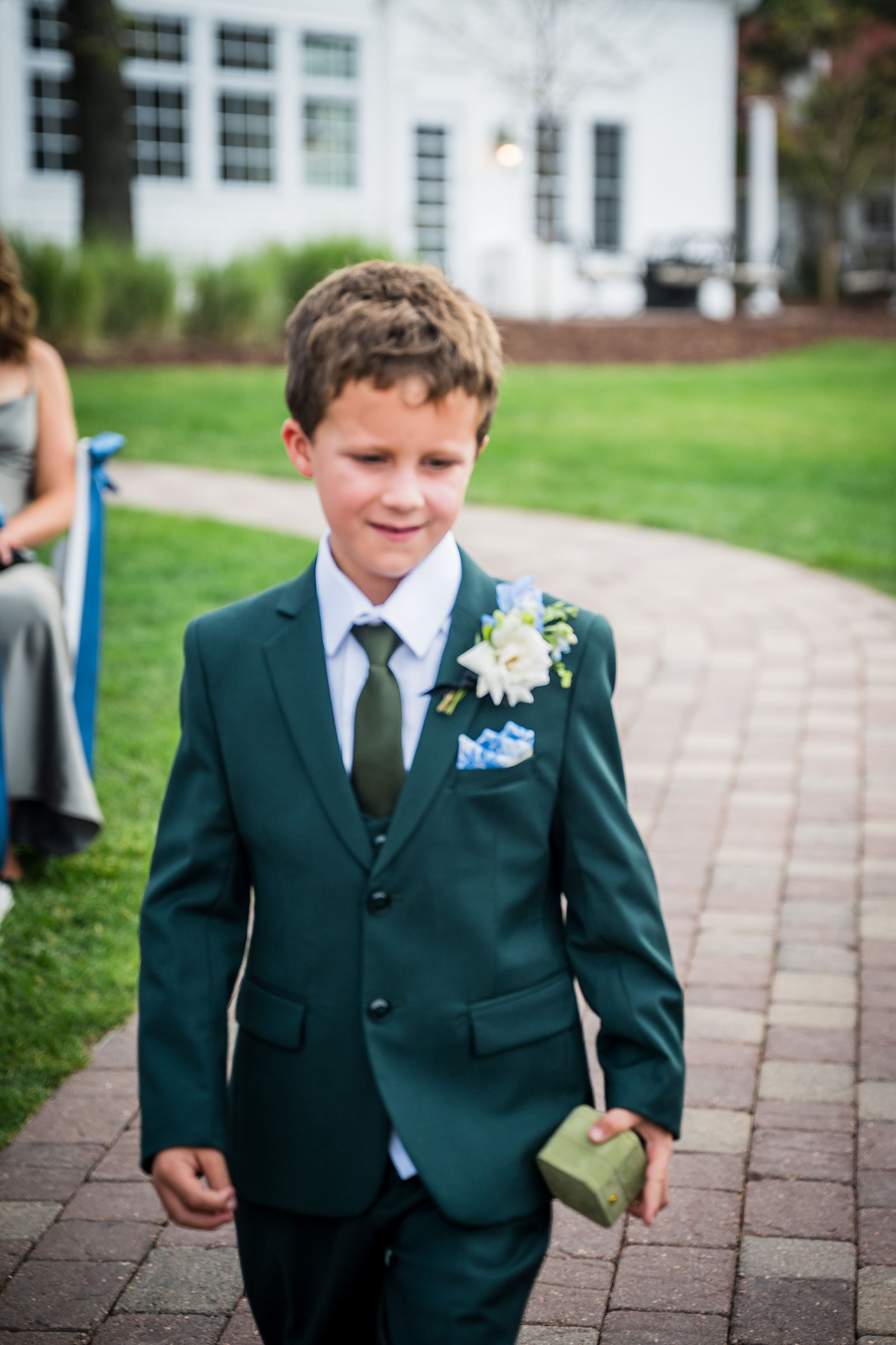 Ring bearer walking the aisle at a Manor House wedding