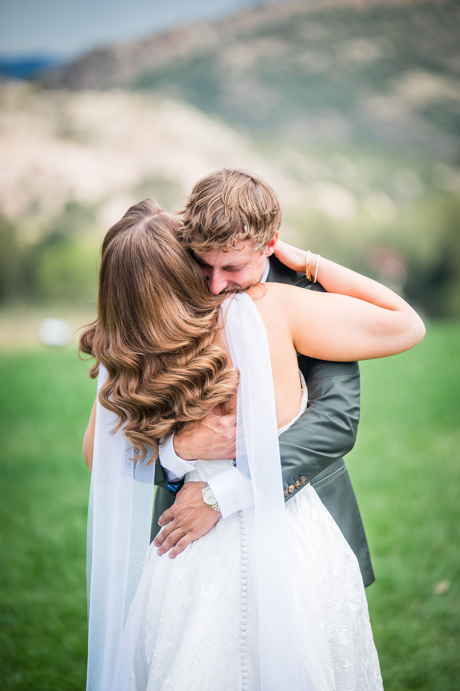 Bride and groom embracing during their first look at the Manor House