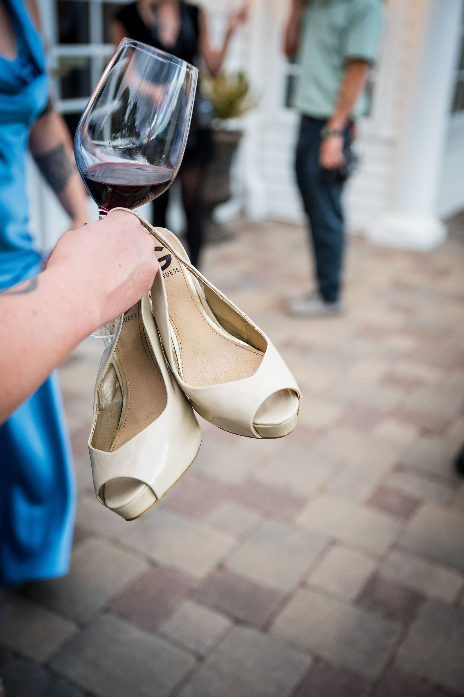 Bride’s heels held up at the reception before she changed into sneakers