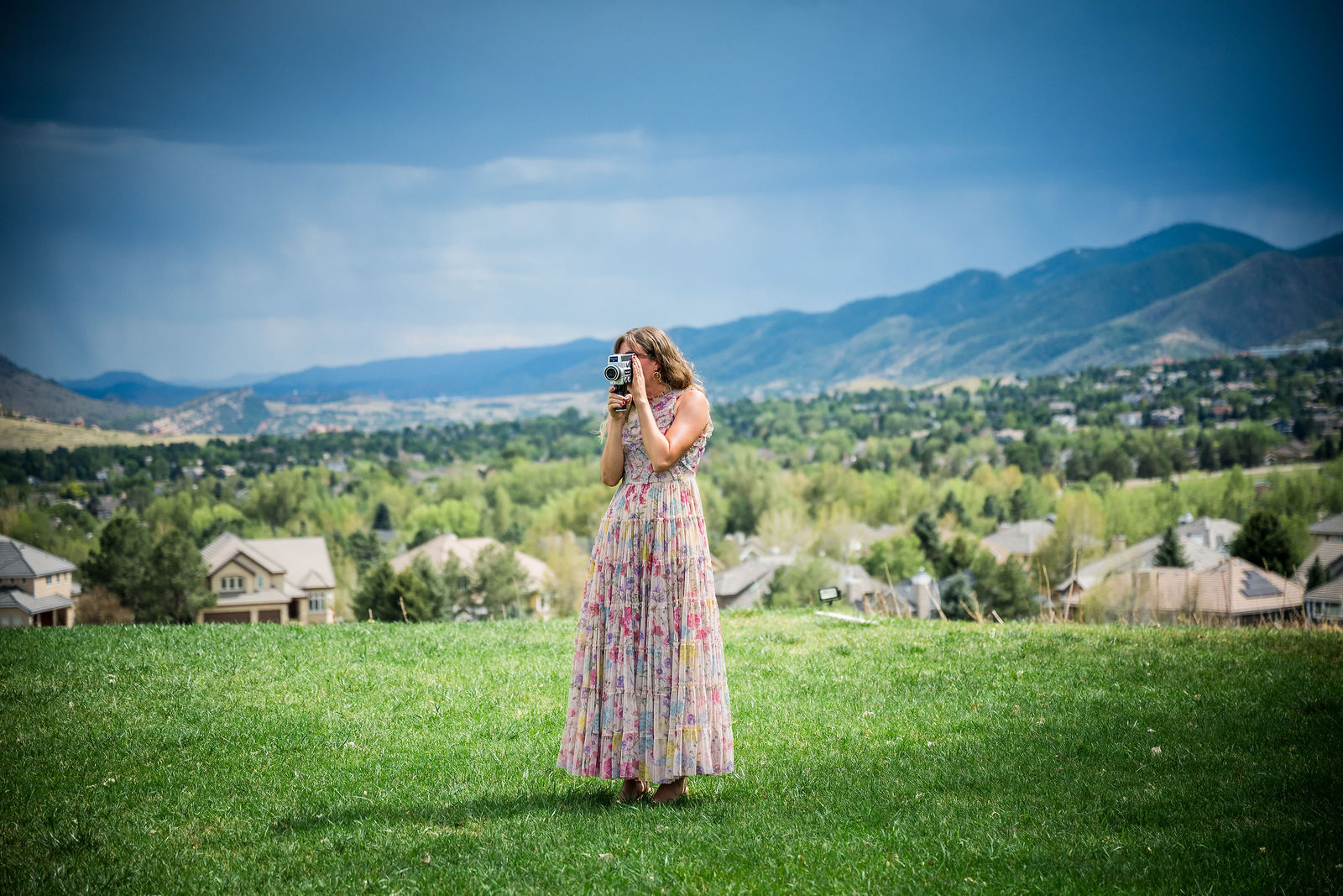 Bride and groom alone on the lawn with the Colorado foothills behind them