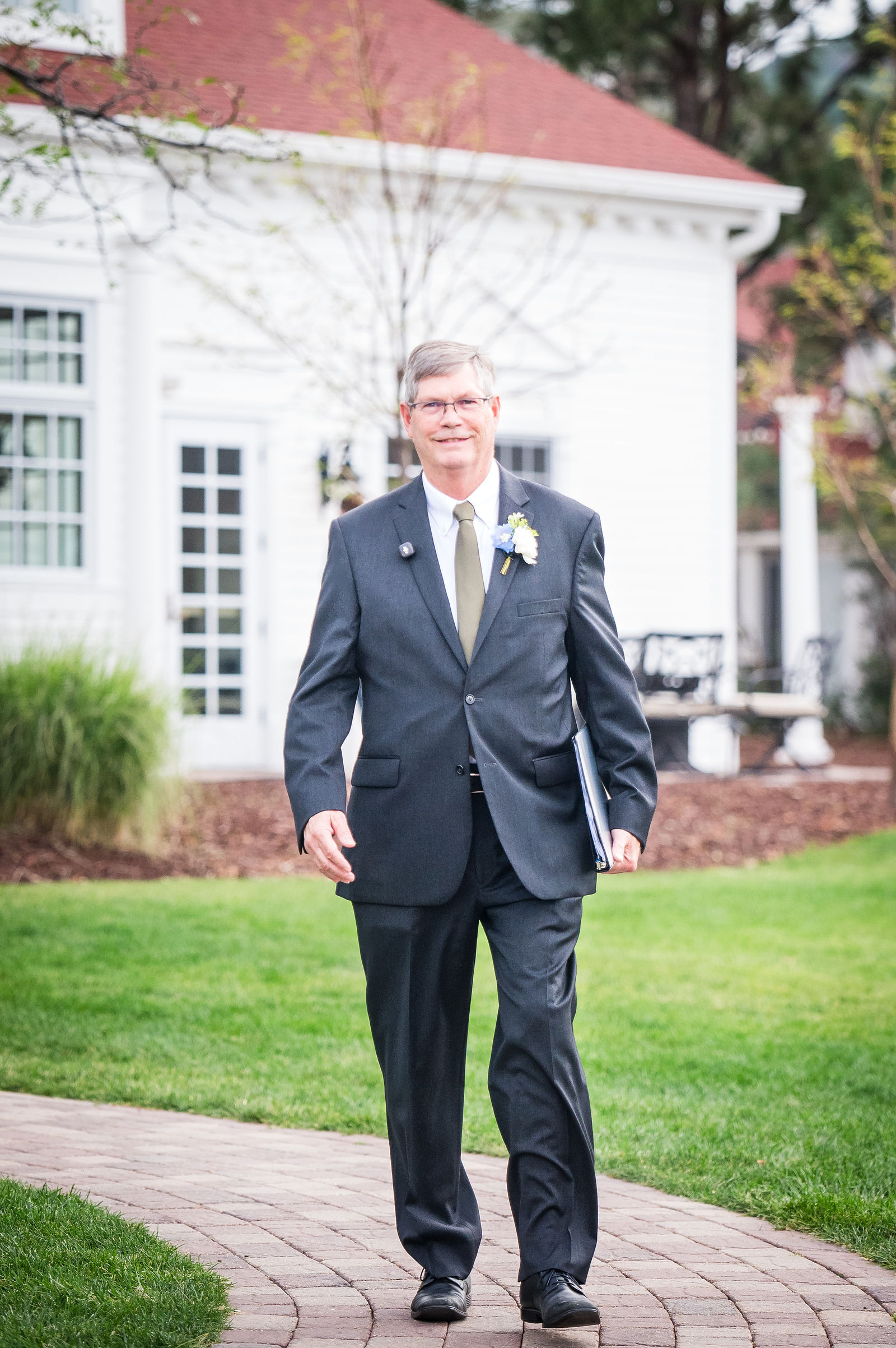 Groom walking out to the ceremony lawn at a Littleton Colorado wedding