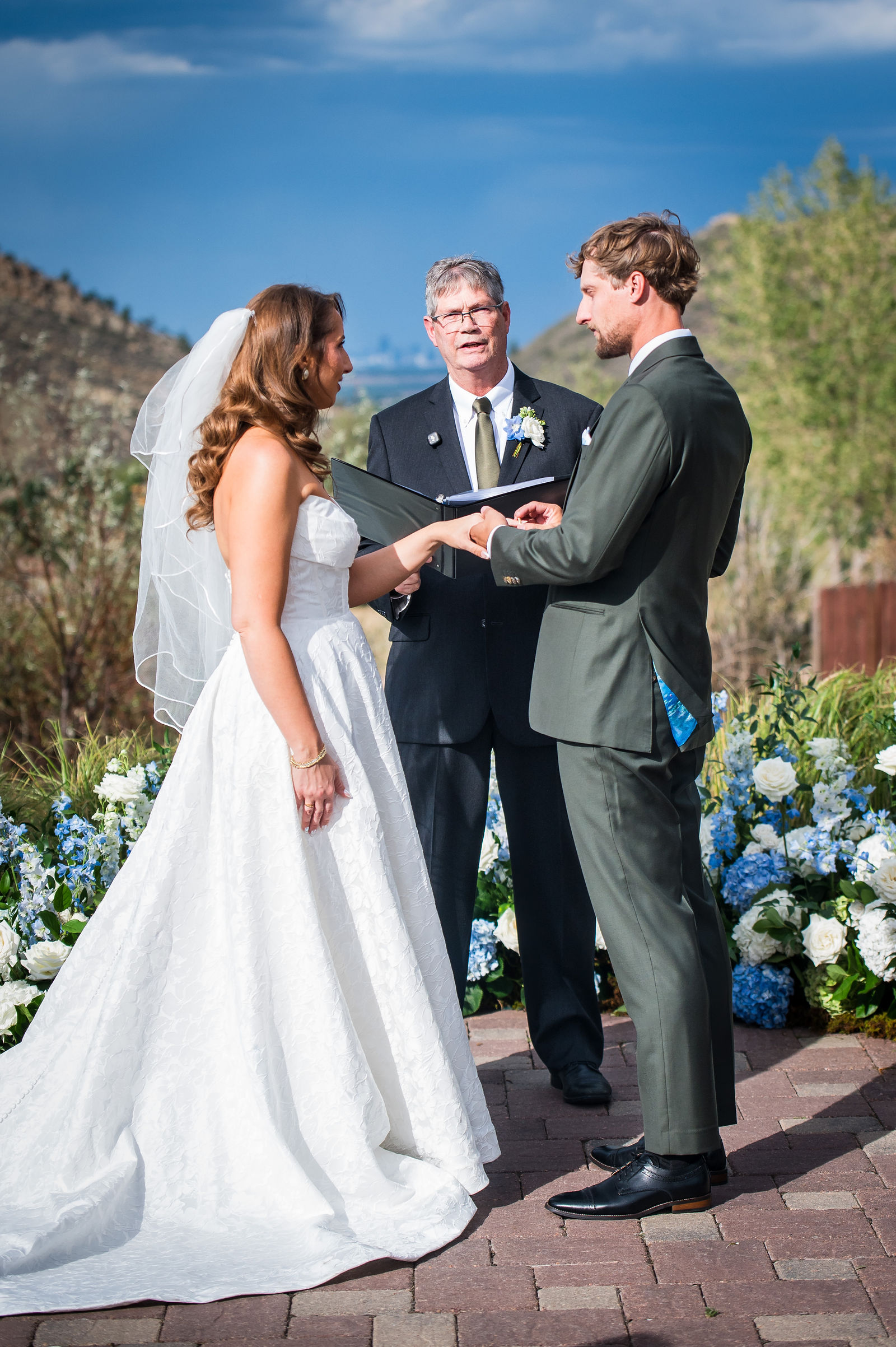 Bride and groom exchanging vows at The Manor House in Littleton, Colorado