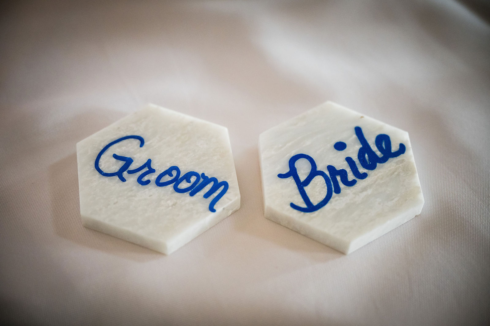 Groom and bride hexagon place cards in dusty blue script