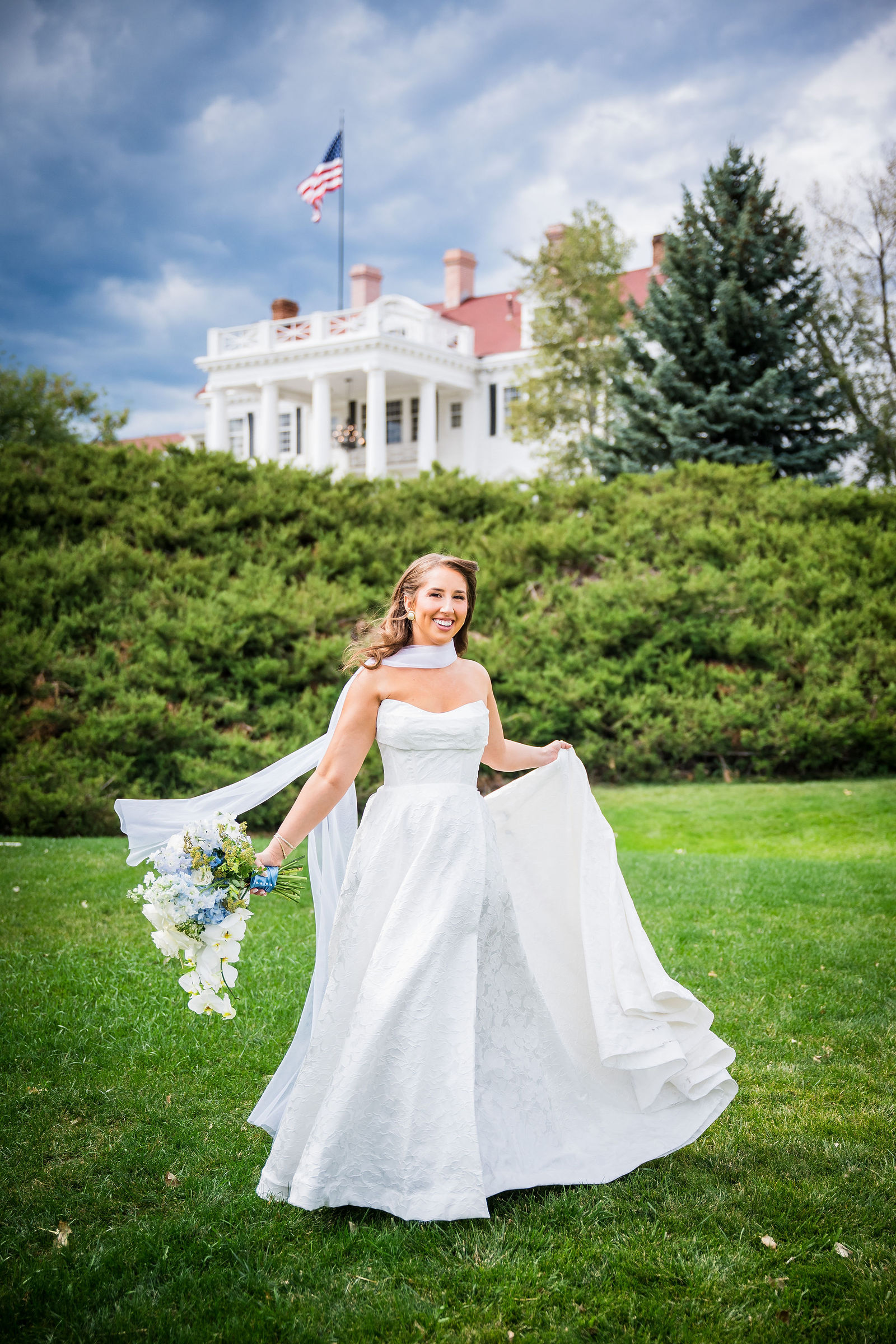 Bride spinning her wedding dress on the Manor House lawn