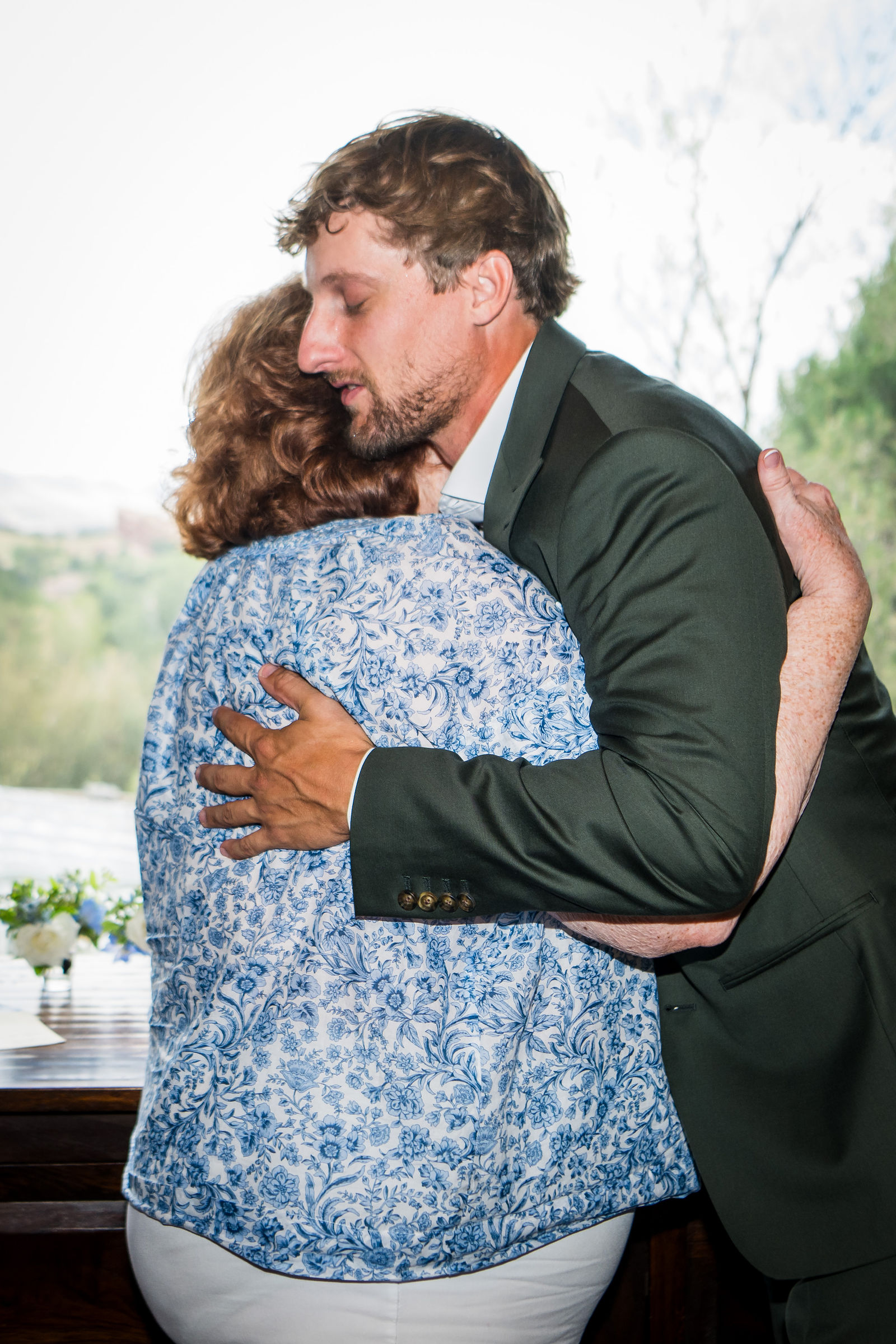 Groom and his mother embracing before his Littleton Colorado wedding