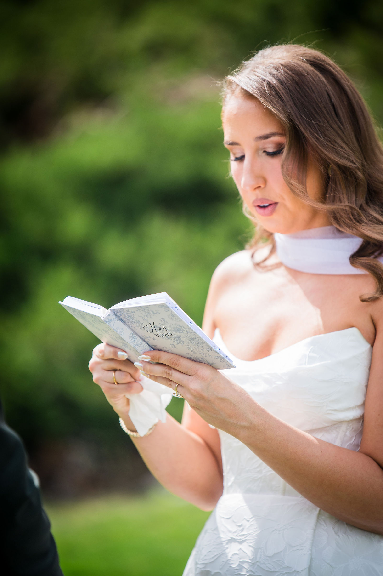 Bride reading her vow book during a private vow exchange