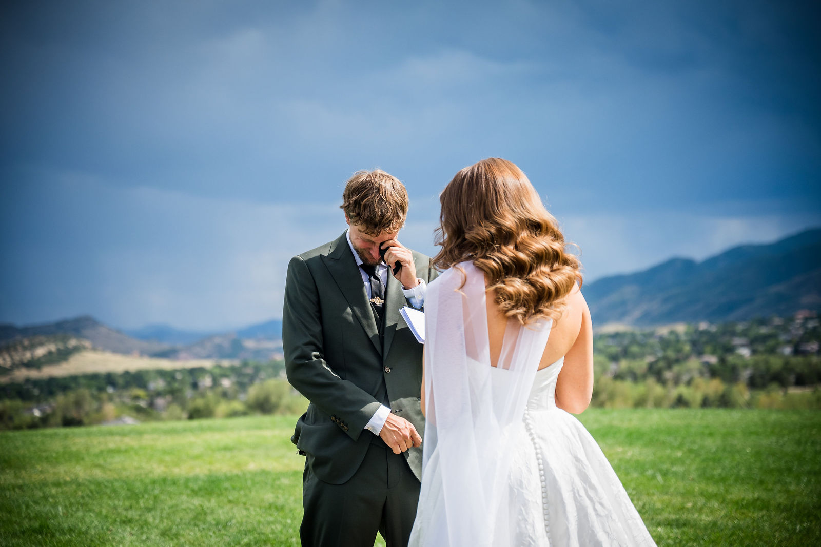 Couple exchanging private vows with the Front Range behind them in Littleton Colorado
