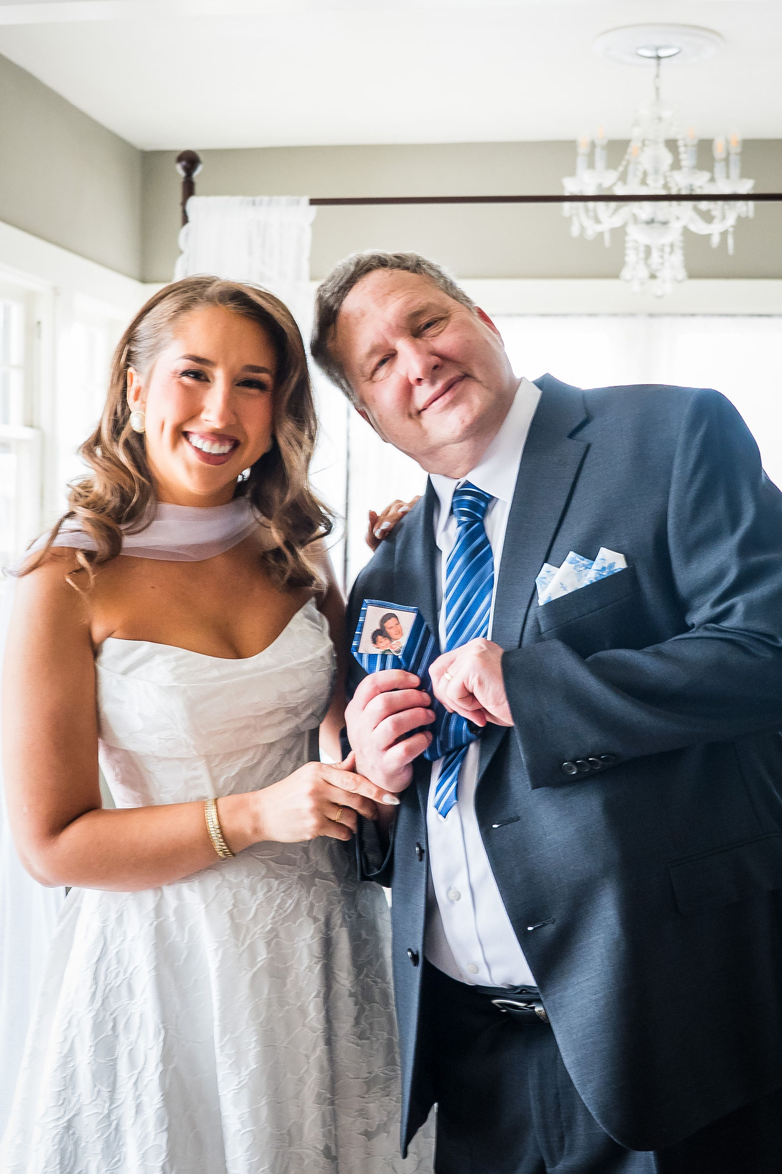 Bride laughing with her dad after their first look at the Manor House