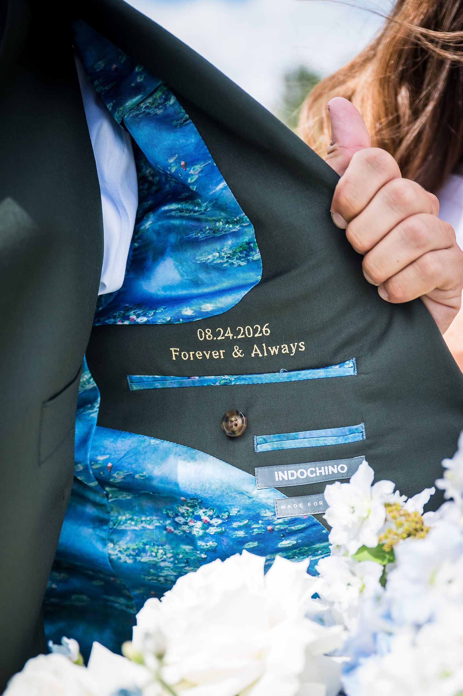 Custom embroidery inside the groom’s olive suit jacket lining