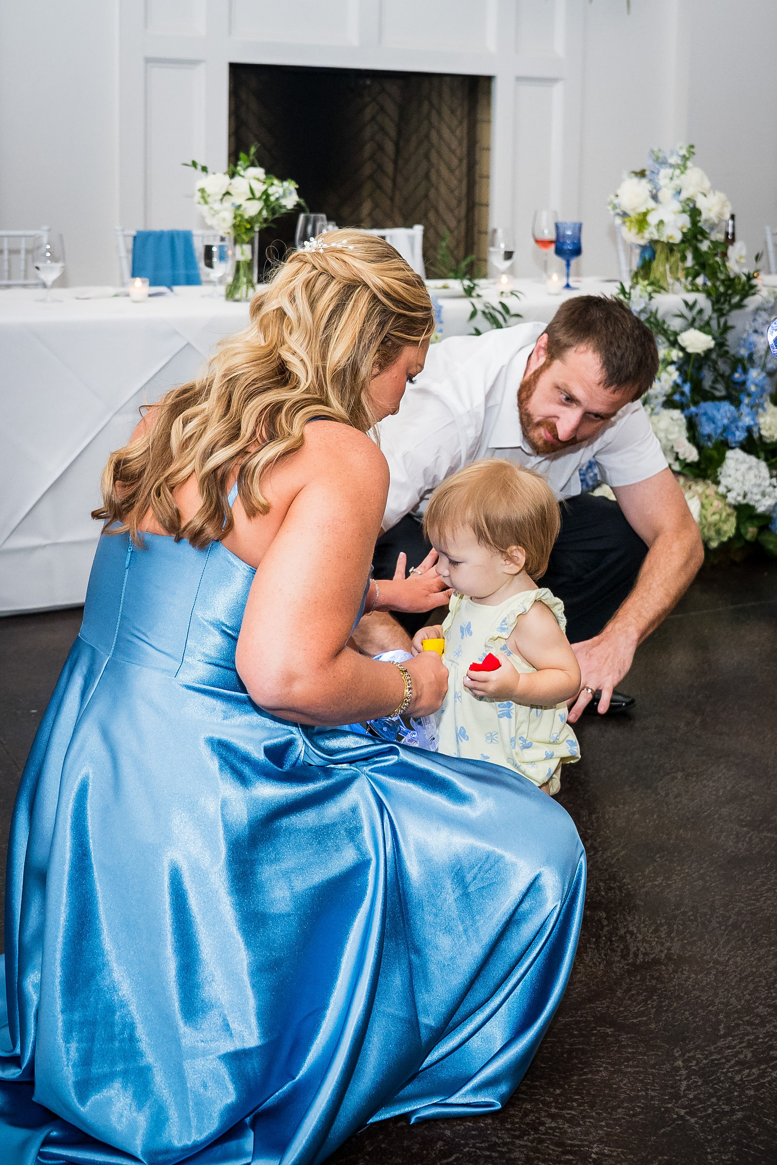 Bride holding a baby on the dance floor at her reception