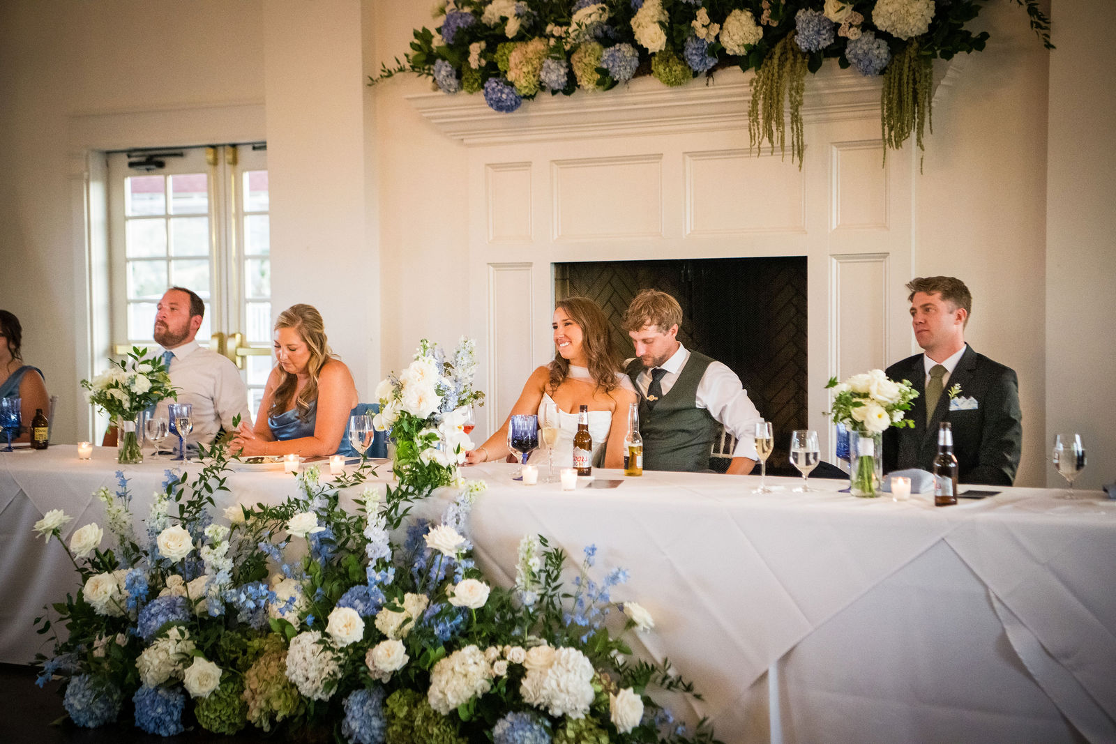 Bride and groom at the head table during reception toasts