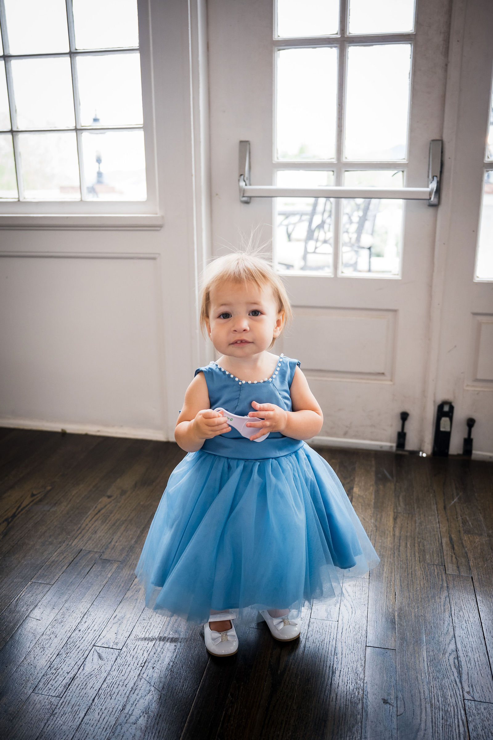 Flower girl in a blue tulle dress before a Manor House wedding