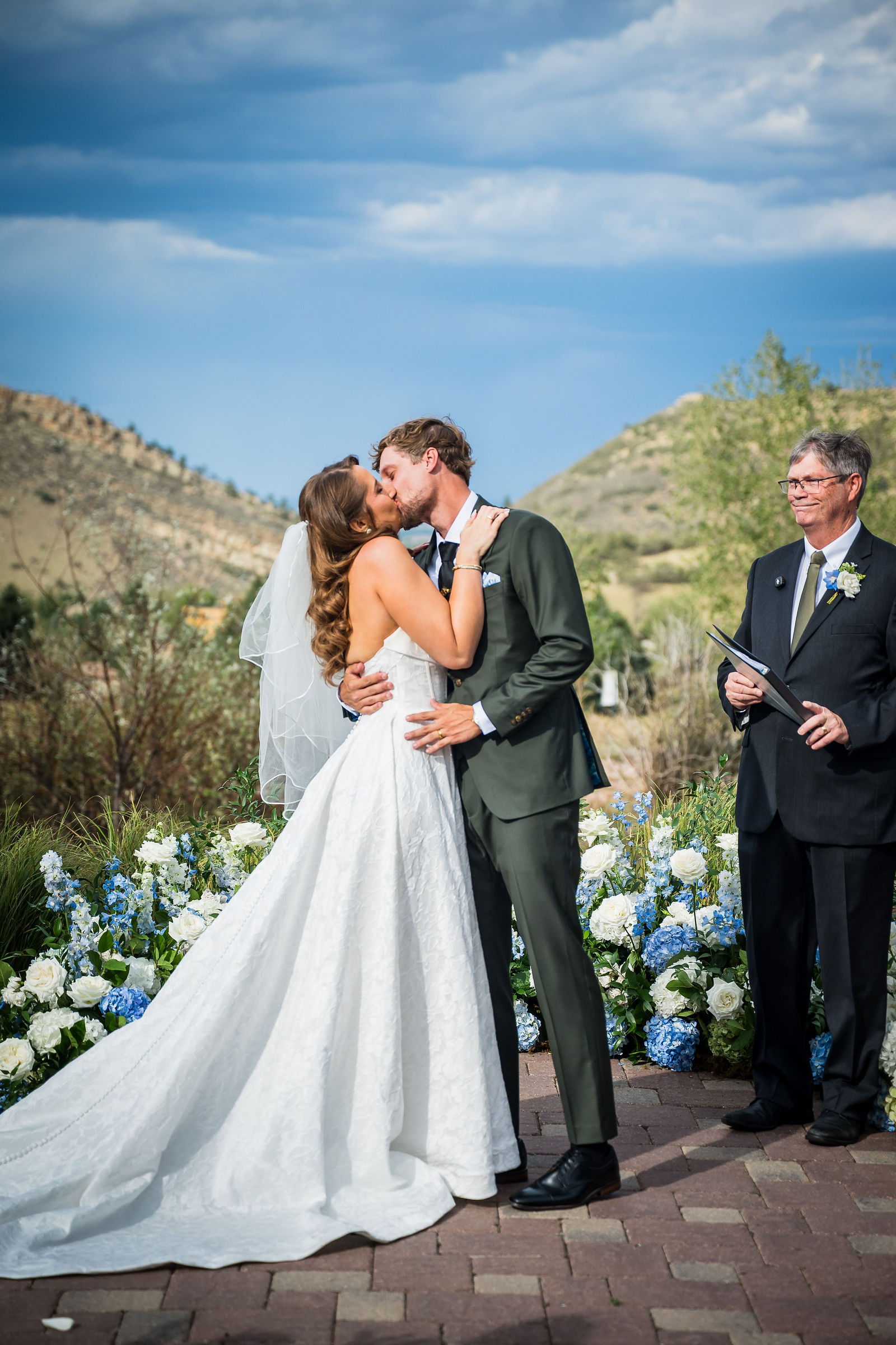 First kiss as a married couple with the Colorado foothills behind them