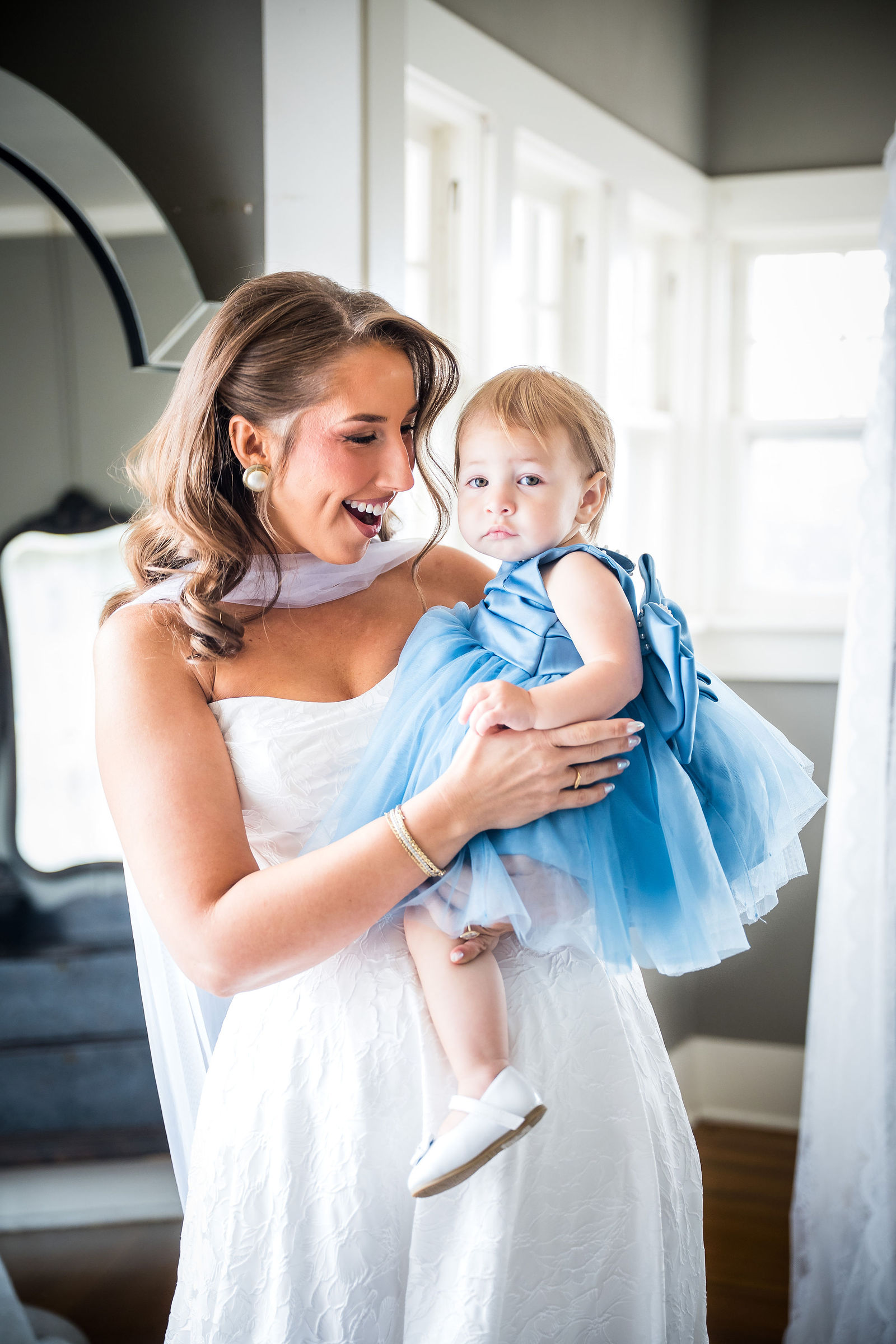 Bride holding her flower girl before a Littleton Colorado wedding