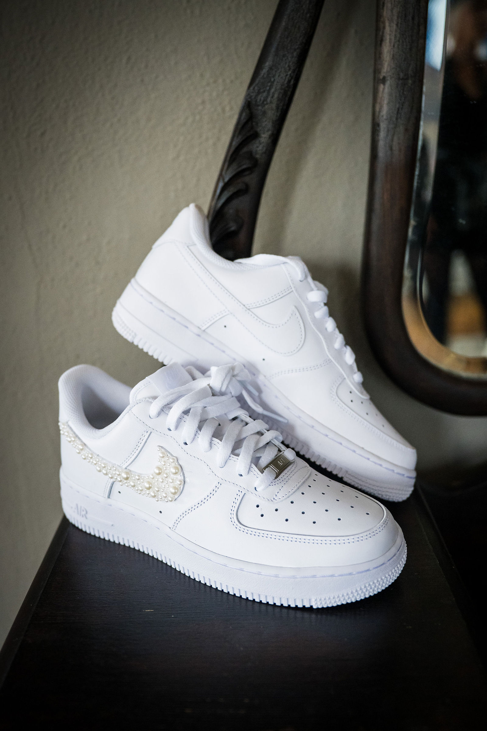 White Air Force 1 sneakers waiting under the wedding dress for the reception