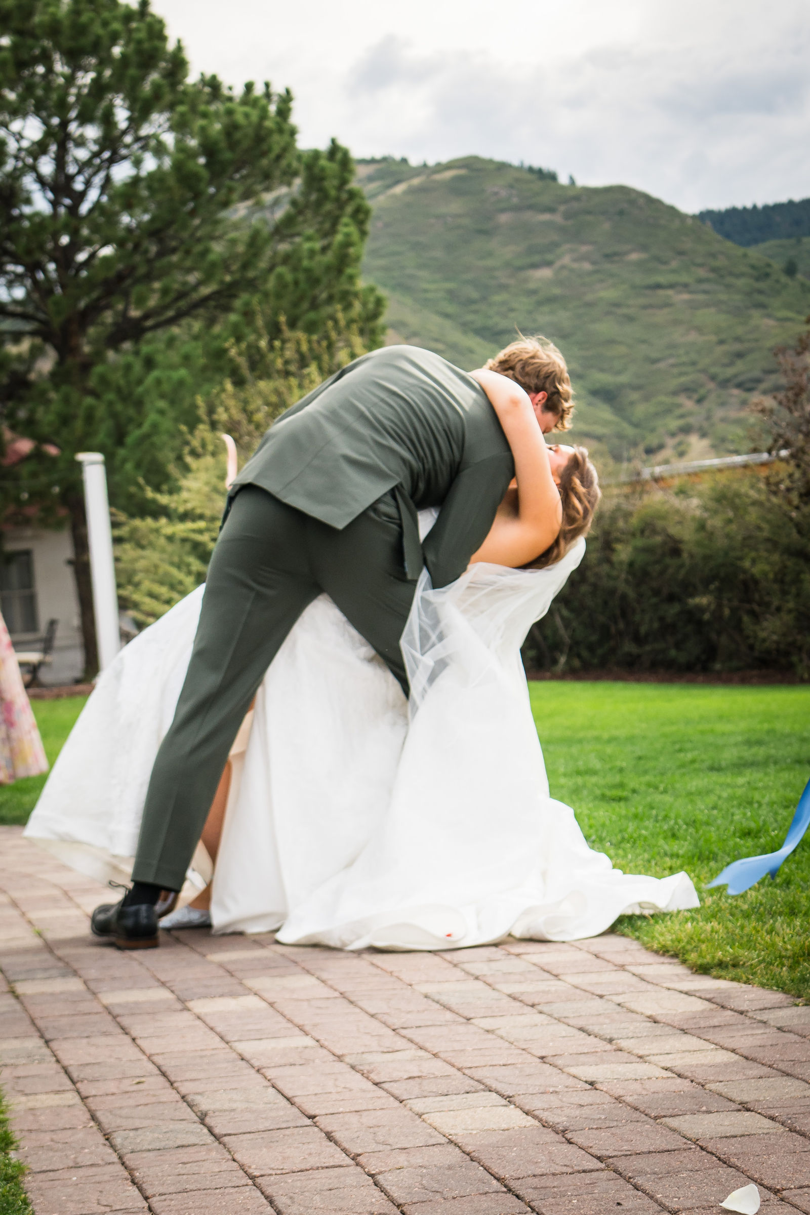 Groom dipping his bride on the lawn right after the ceremony