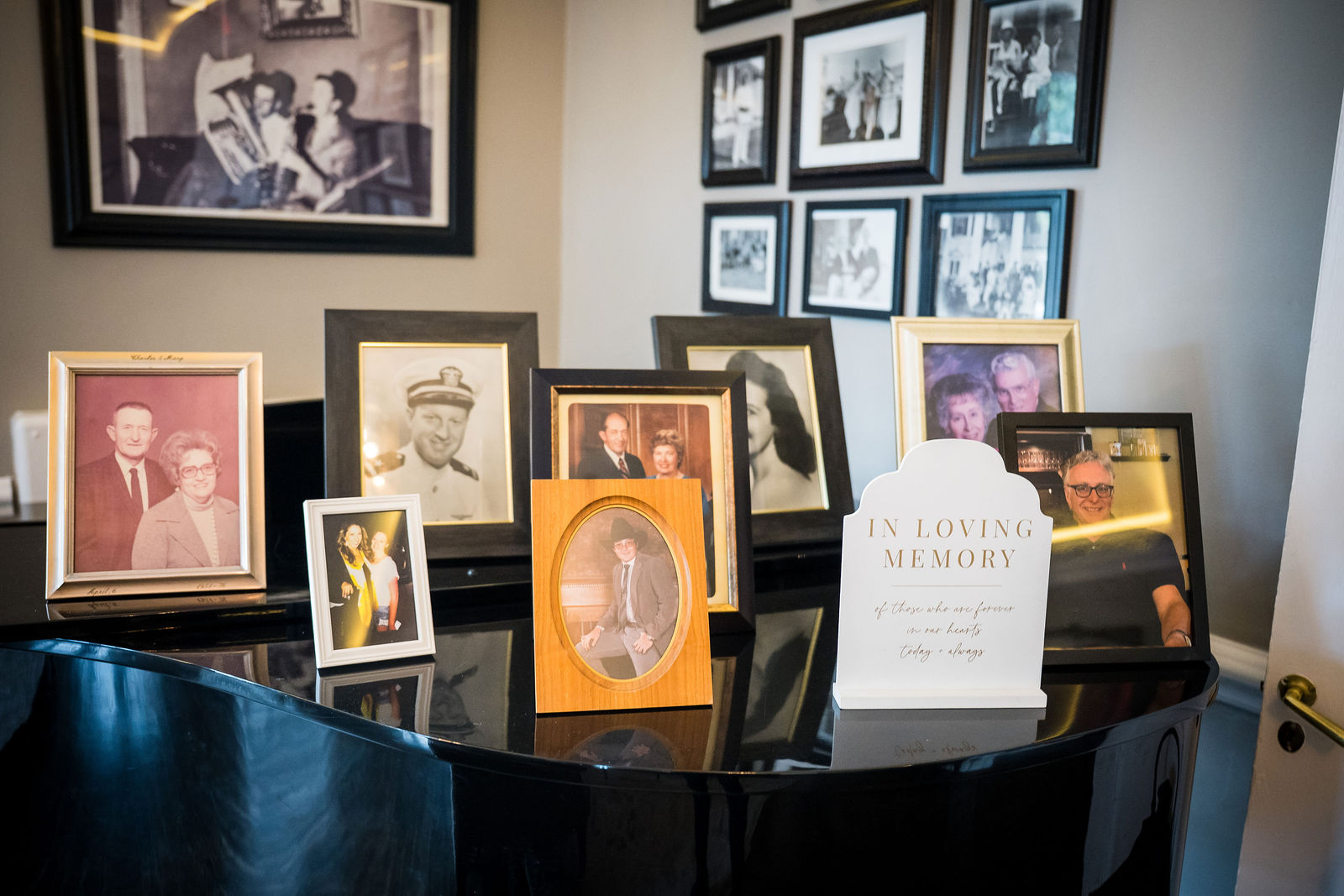 Memory table of framed family photographs at a Manor House wedding