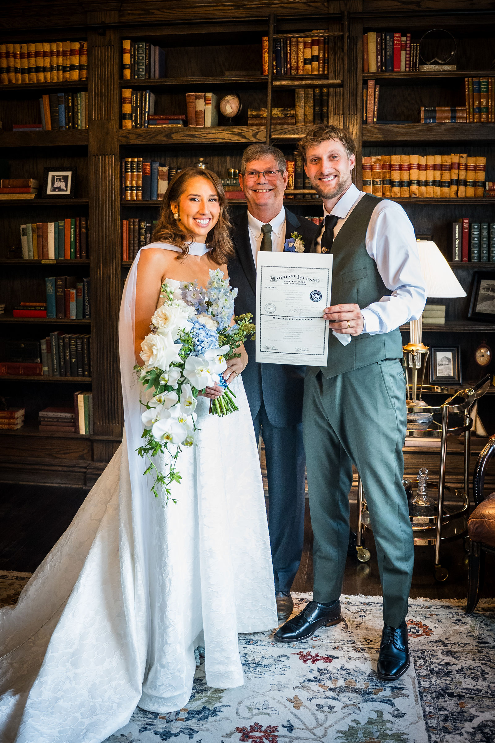 Newly married couple with their marriage license in the Manor House library