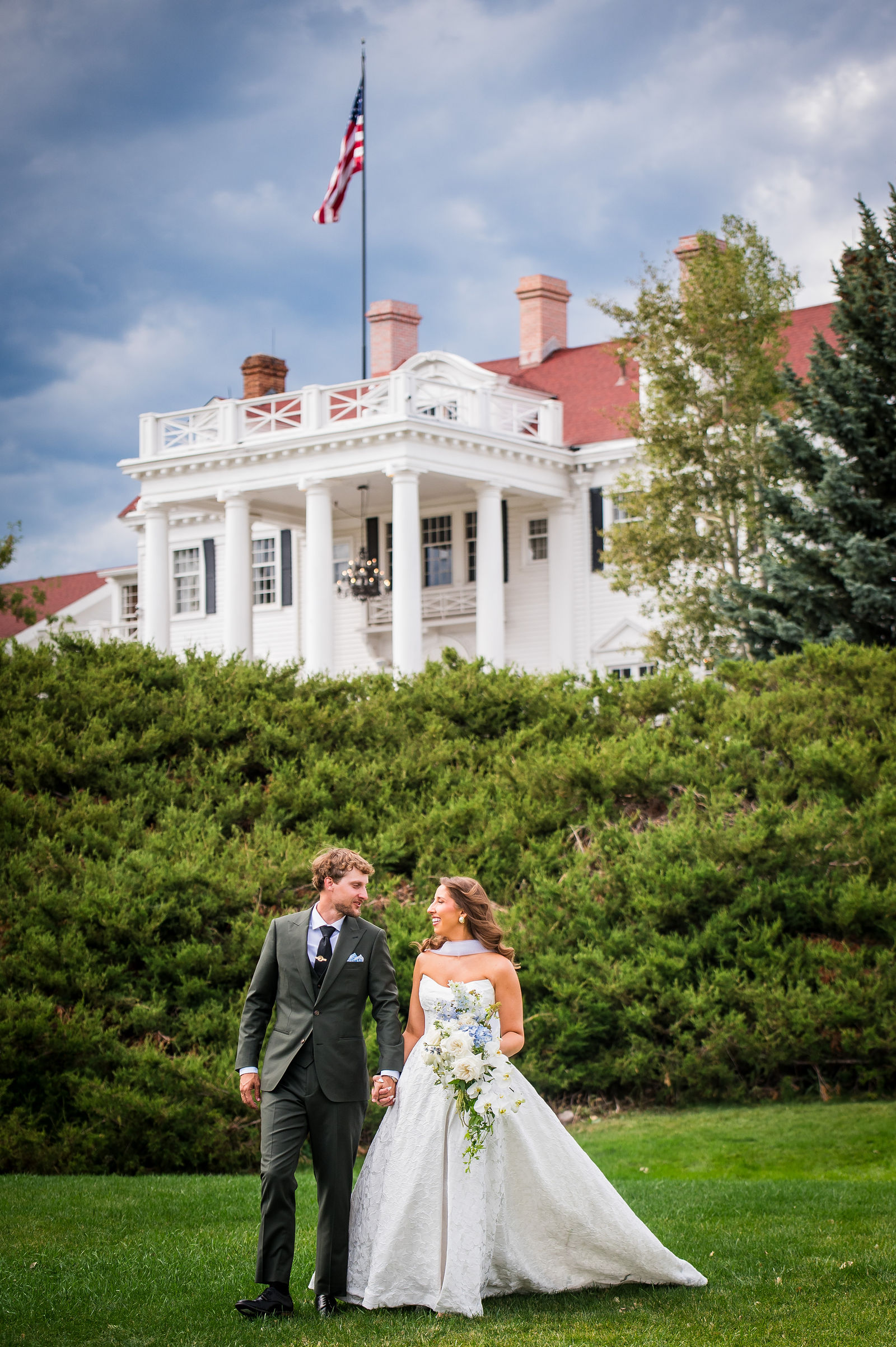 Bride and groom in front of the historic Manor House in Littleton