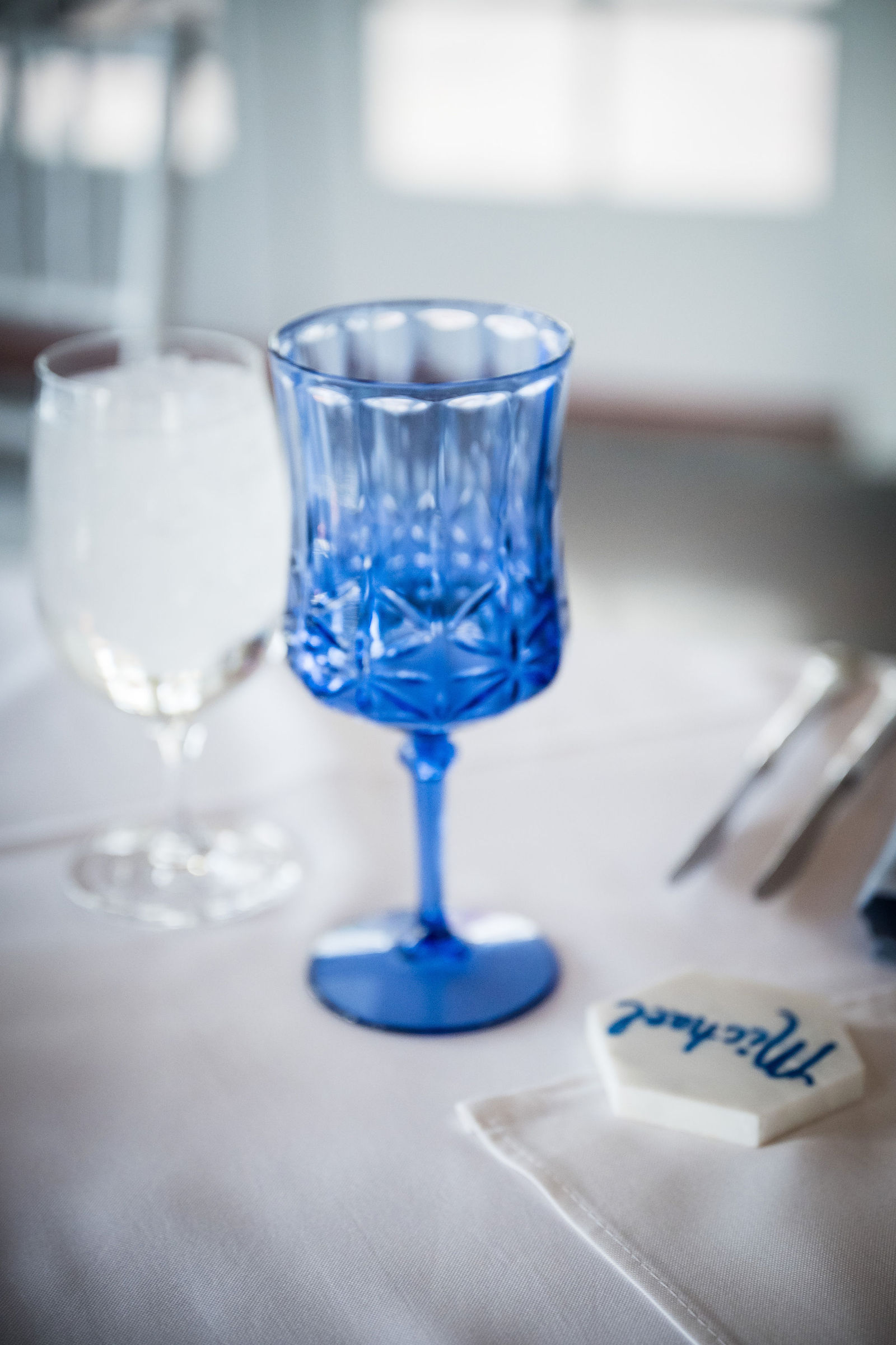 Blue glass goblet on a navy reception table at the Manor House