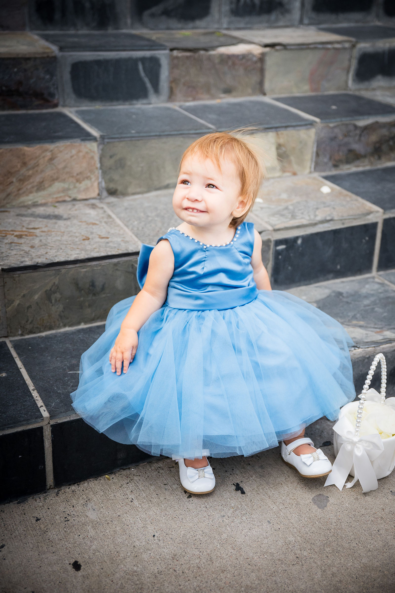 Flower girl in blue tulle during cocktail hour at the Manor House
