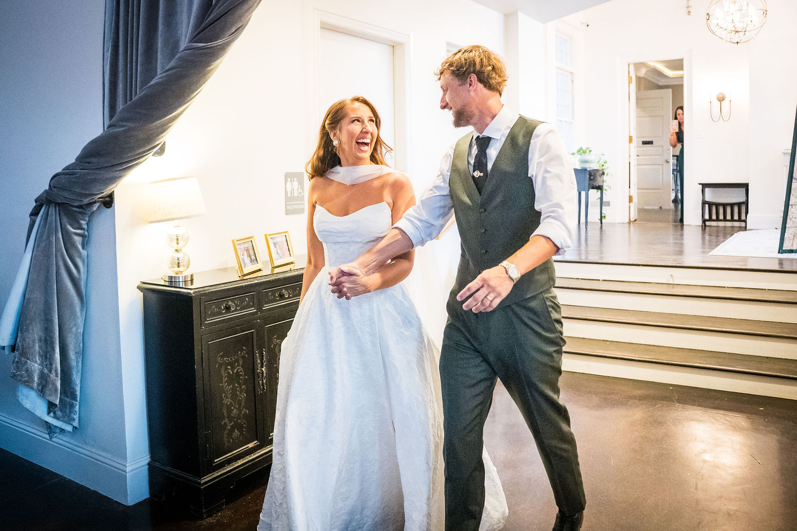 Bride and groom entering their reception at the Manor House