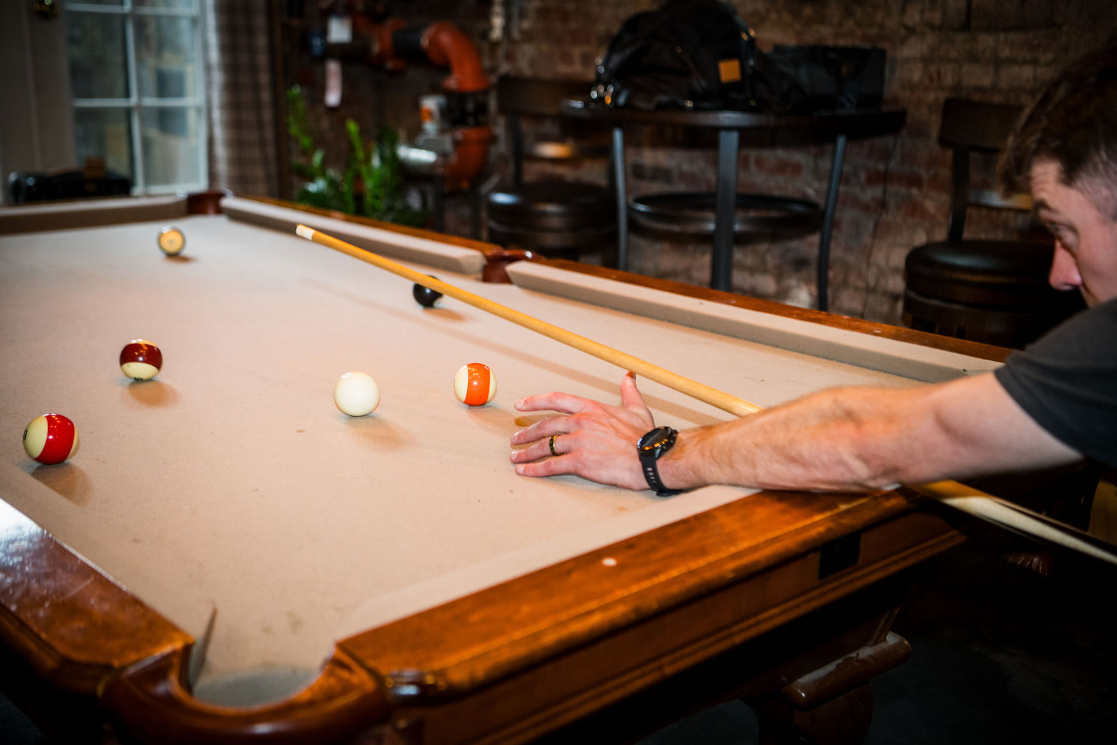 Groomsmen playing pool in the groom’s room at the Manor House in Littleton
