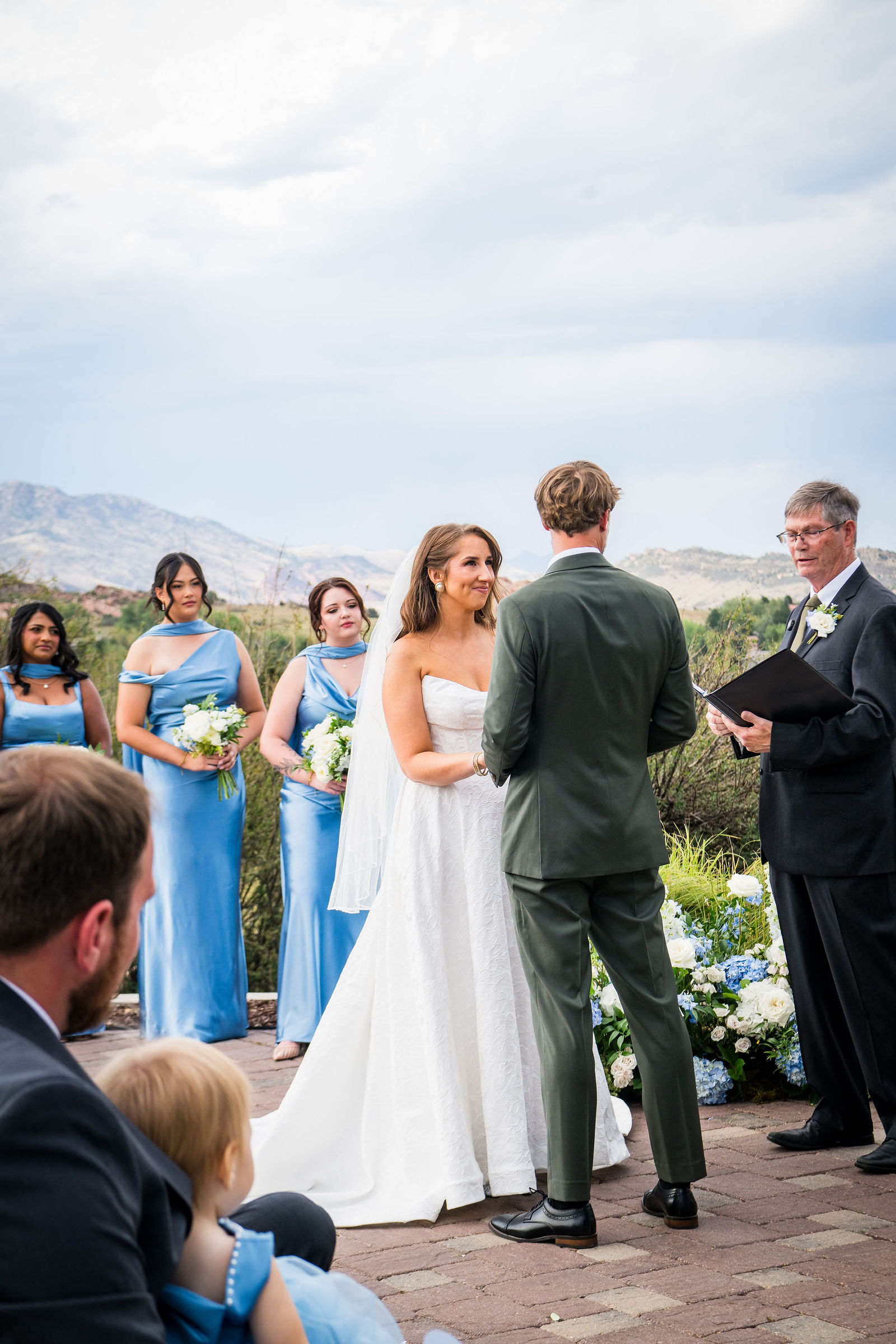 Bride and groom exchanging vows with the Colorado foothills behind them