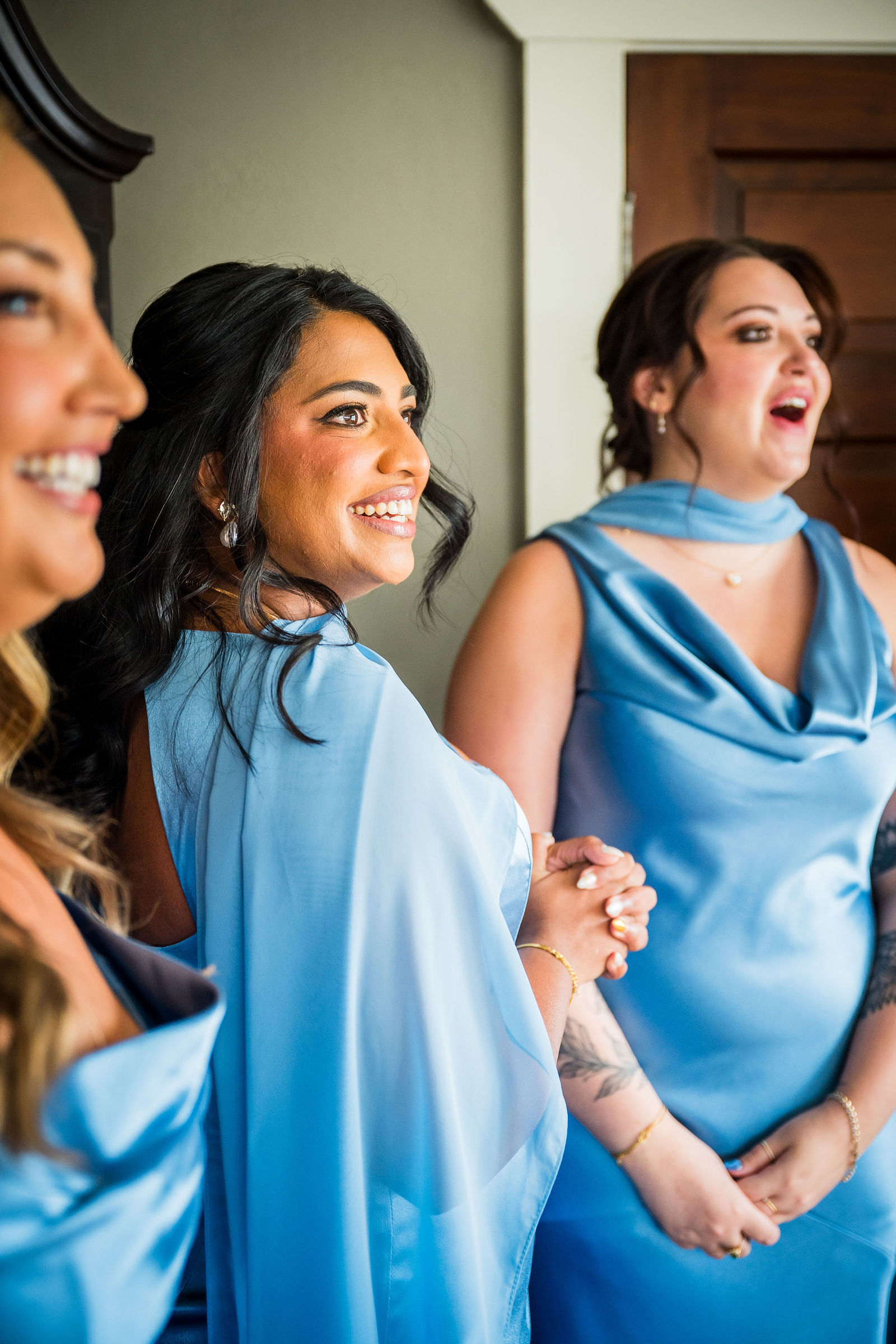 Emotional bridesmaid seeing the bride in her dress for the first time