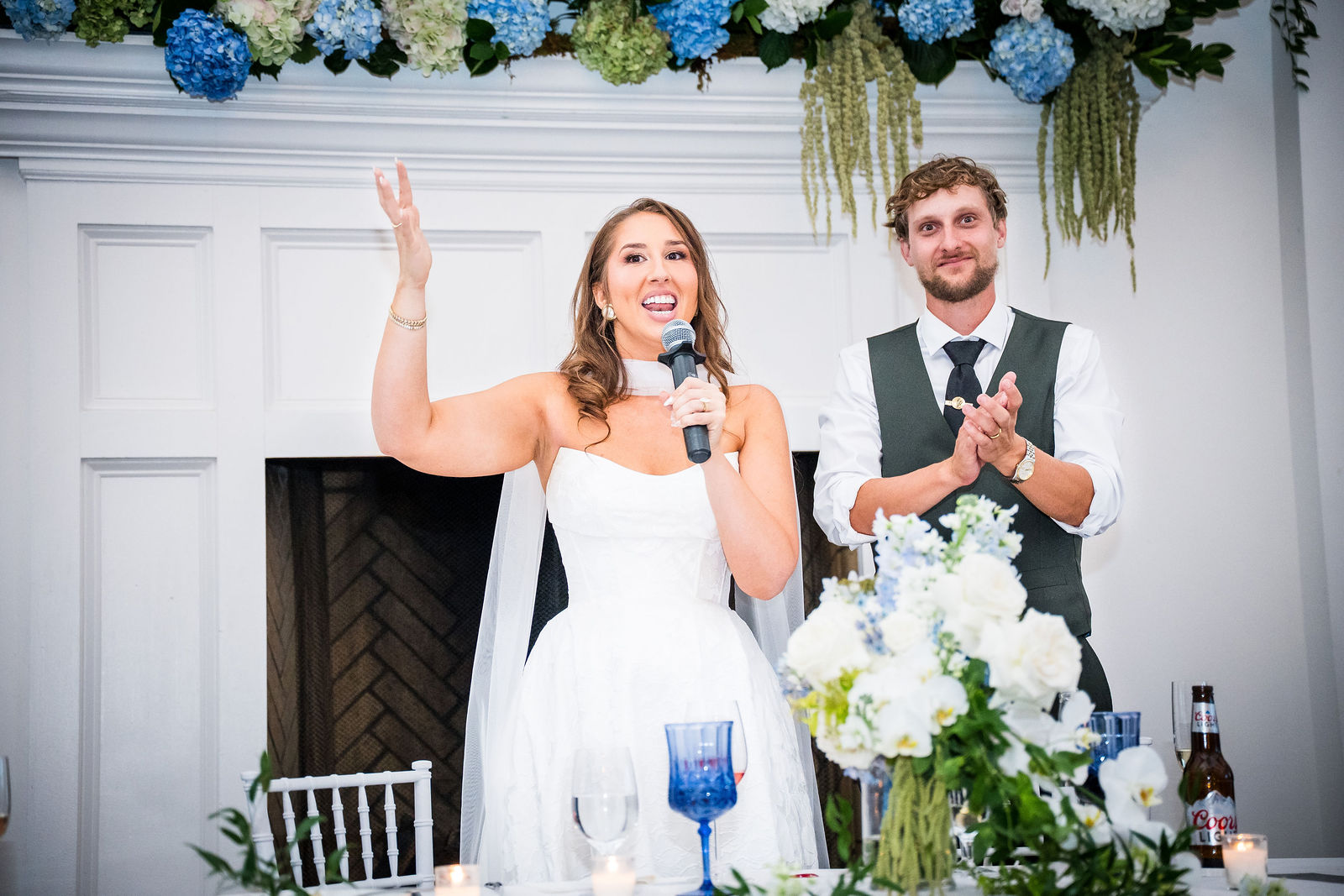 Bride speaking to her guests at her own wedding reception