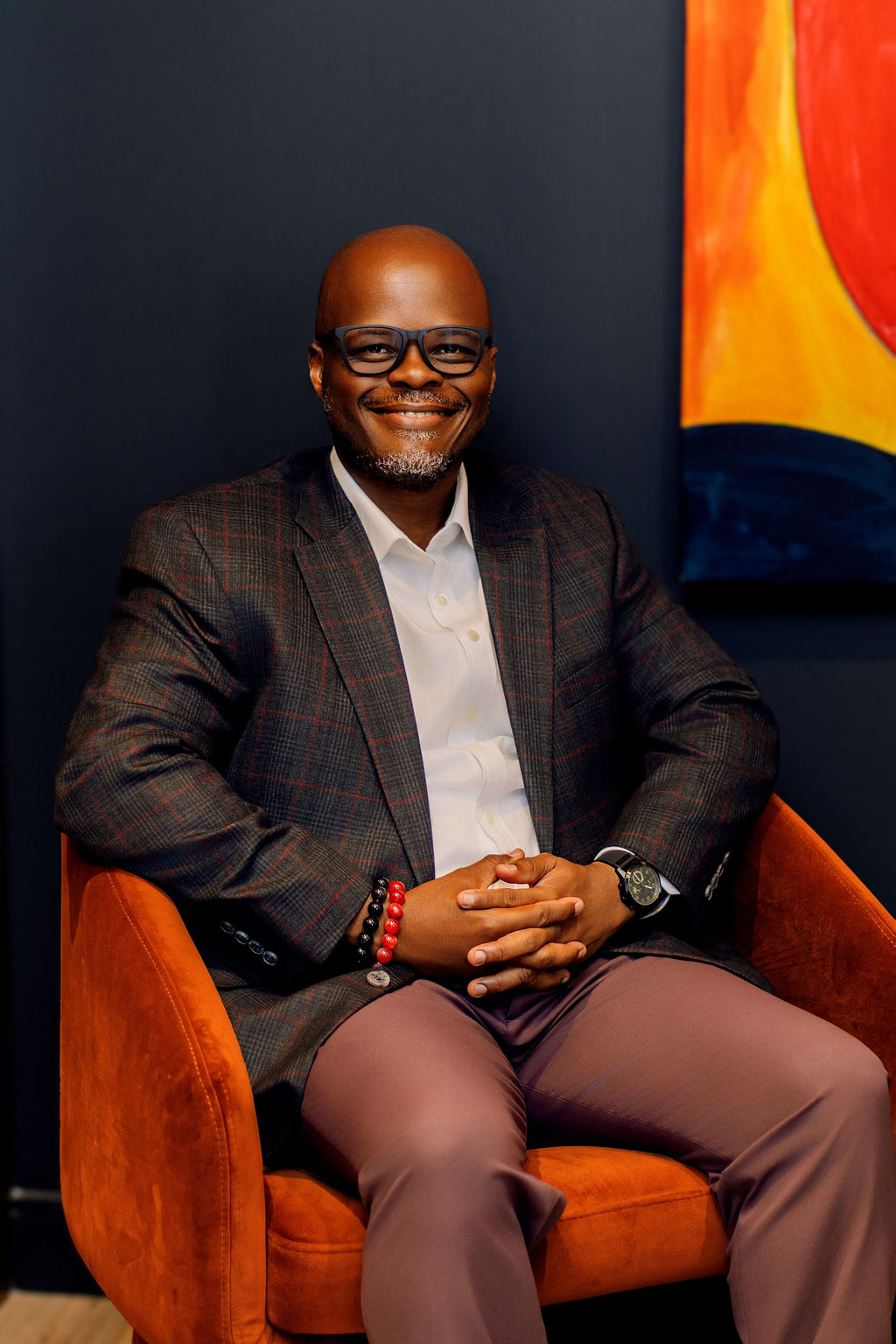 Mobolaji seated, in discussion