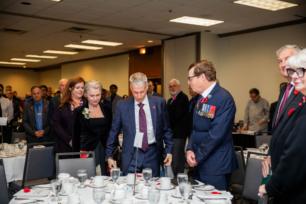 A full room standing at the Veterans' Tribute Lunch