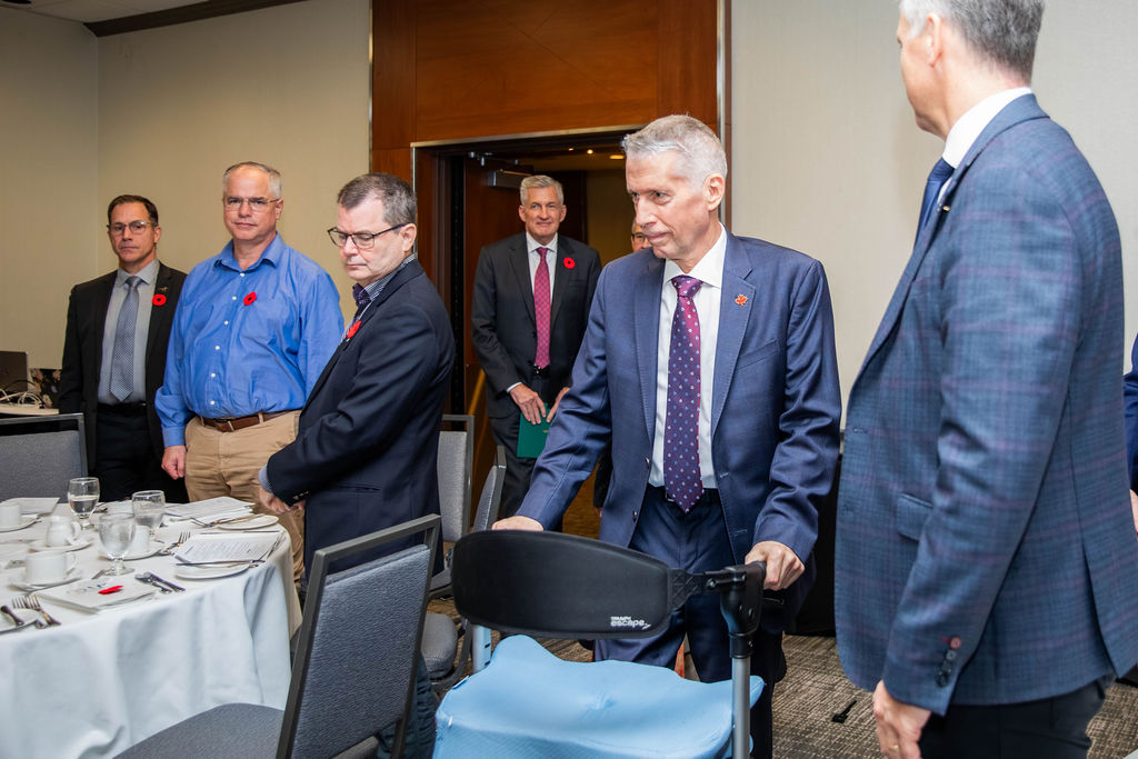 A piper leading guests into the room