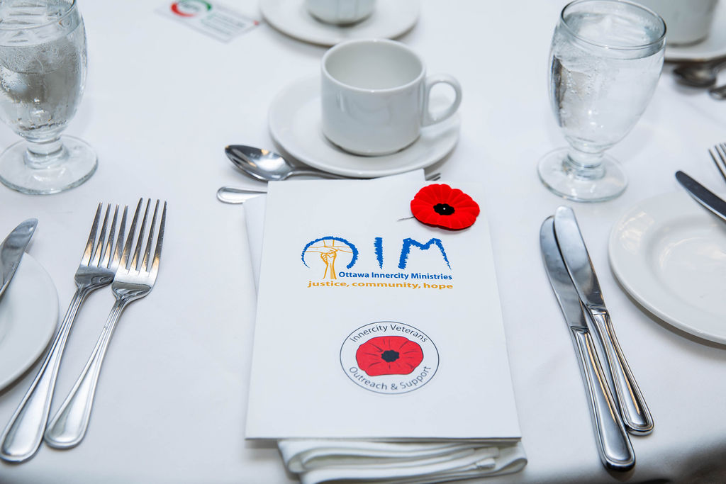 A poppy and program at a place setting
