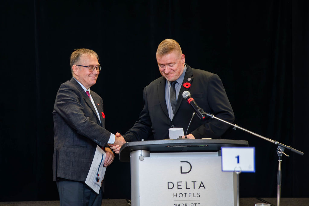 A handshake at the podium