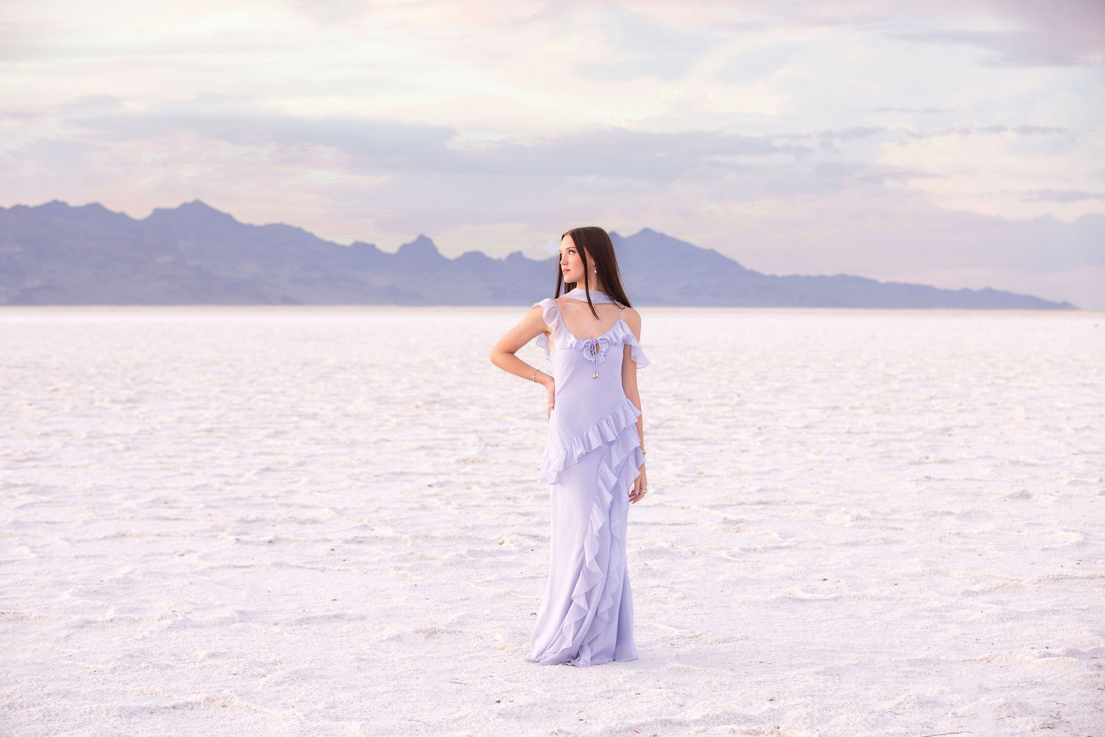 Savannah posing for senior photos at the Bonneville Salt Flats in Utah at sunset