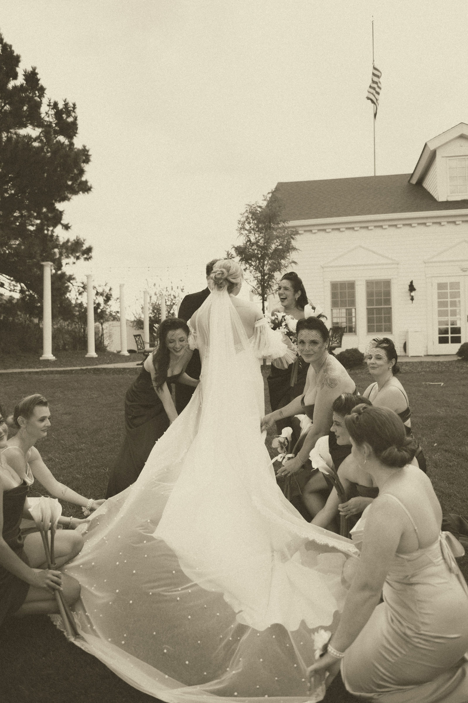 Bride laughing with her bridesmaids at The Manor House