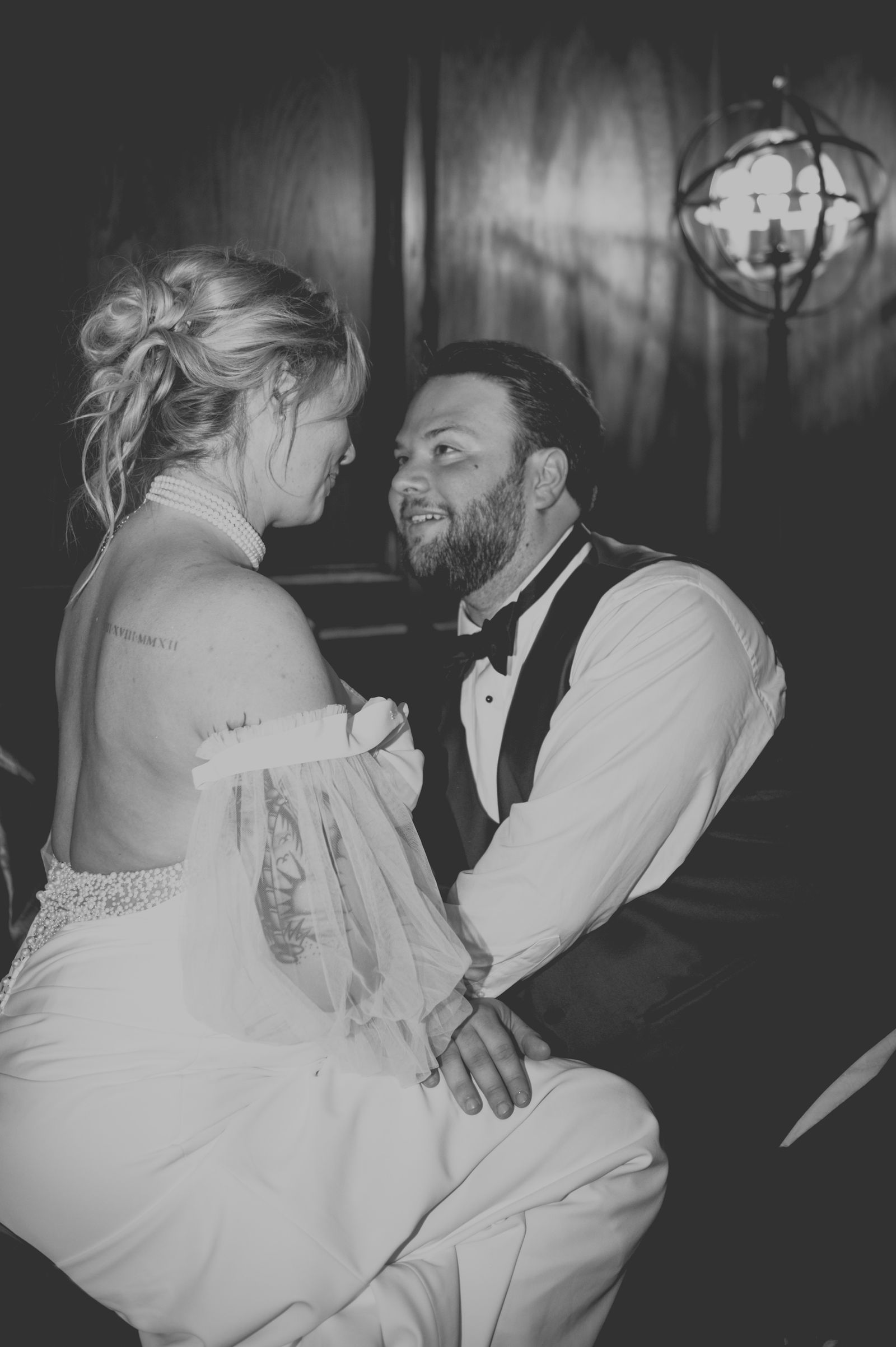 Night portrait of the bride and groom kissing in dramatic shadow