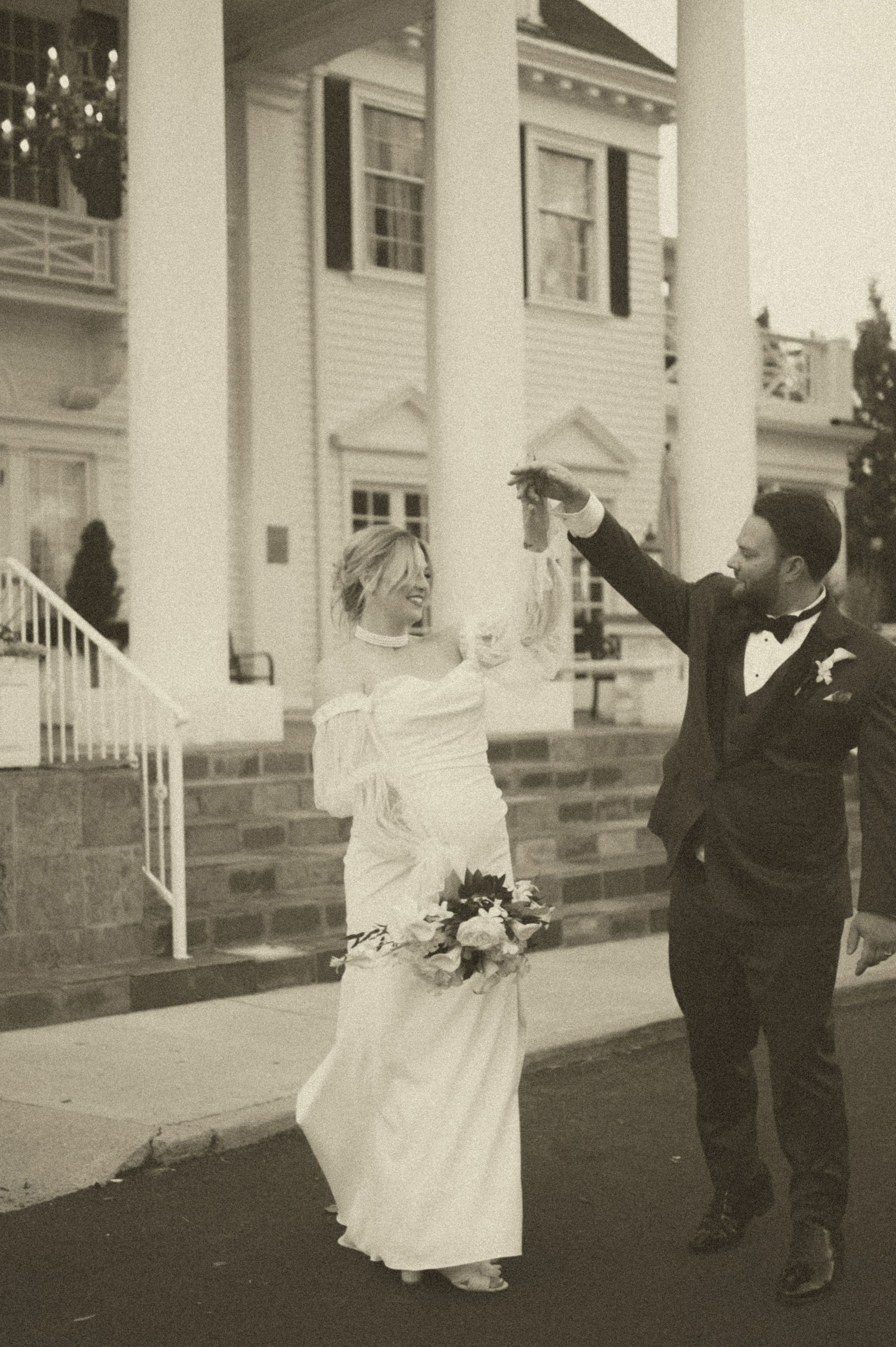 Bride and groom laughing as they walk together at The Manor House