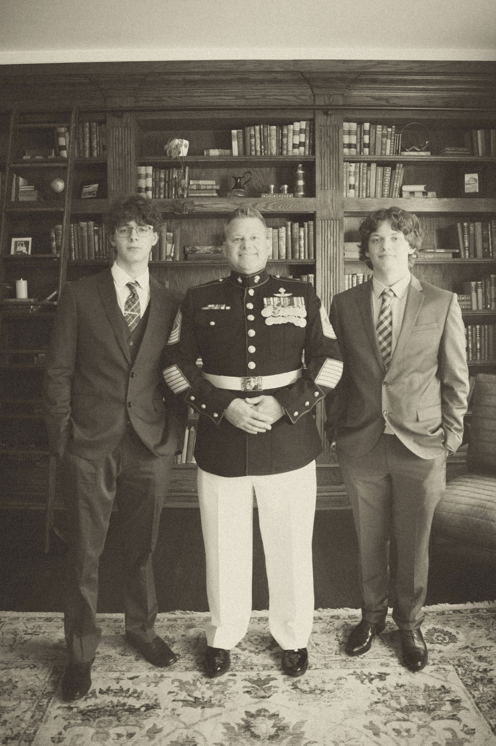 Groomsmen in black tuxedos and dress uniform before the ceremony
