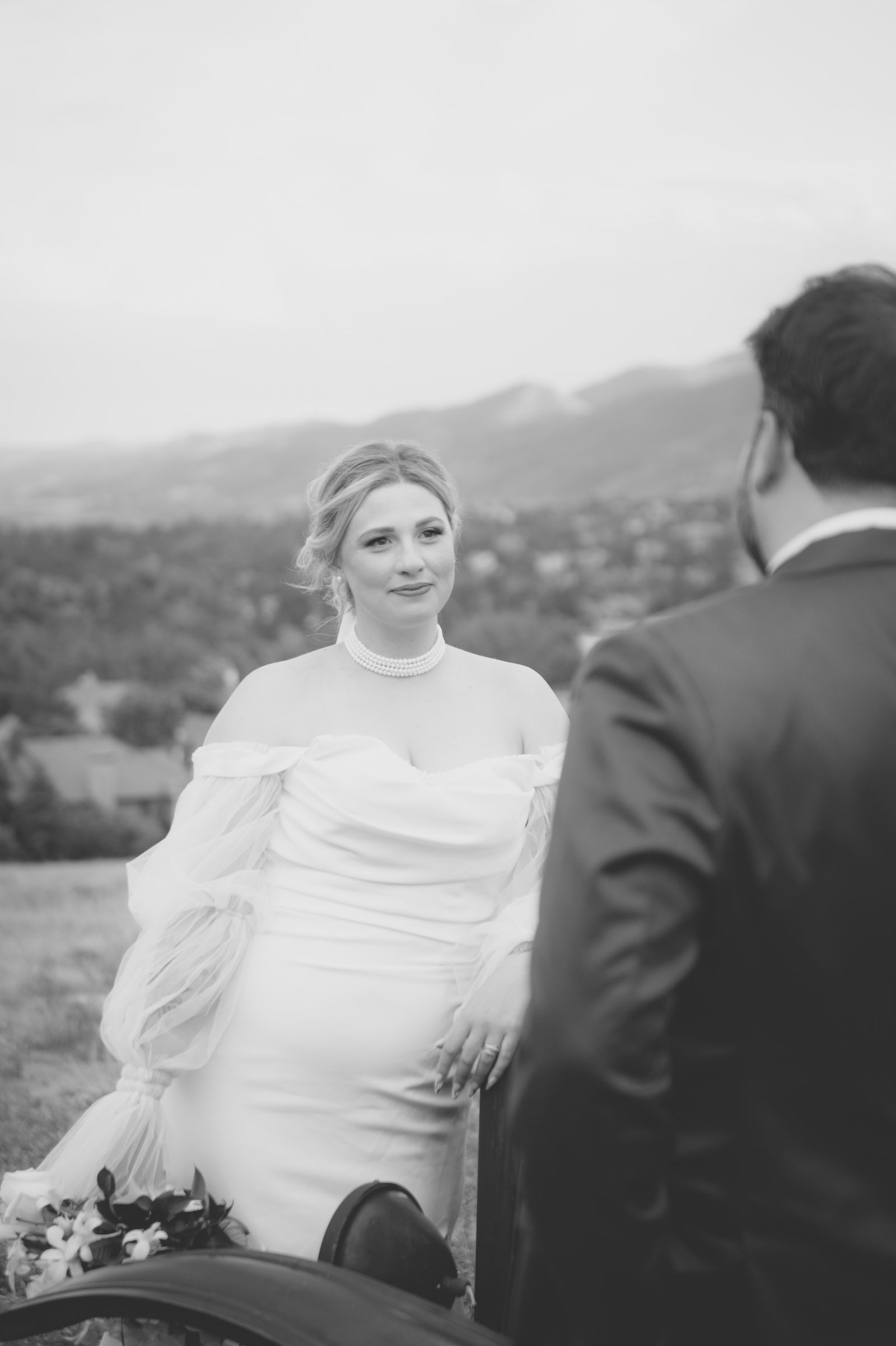 Colorado foothills behind the bride and groom during sunset portraits