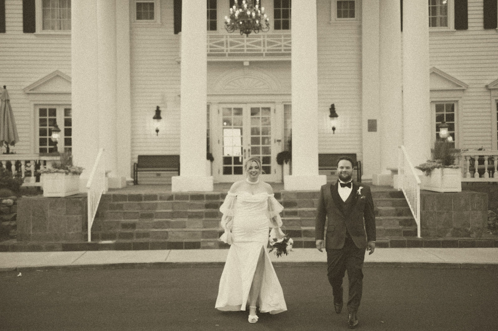 Bride and groom on the front steps of The Manor House in Littleton