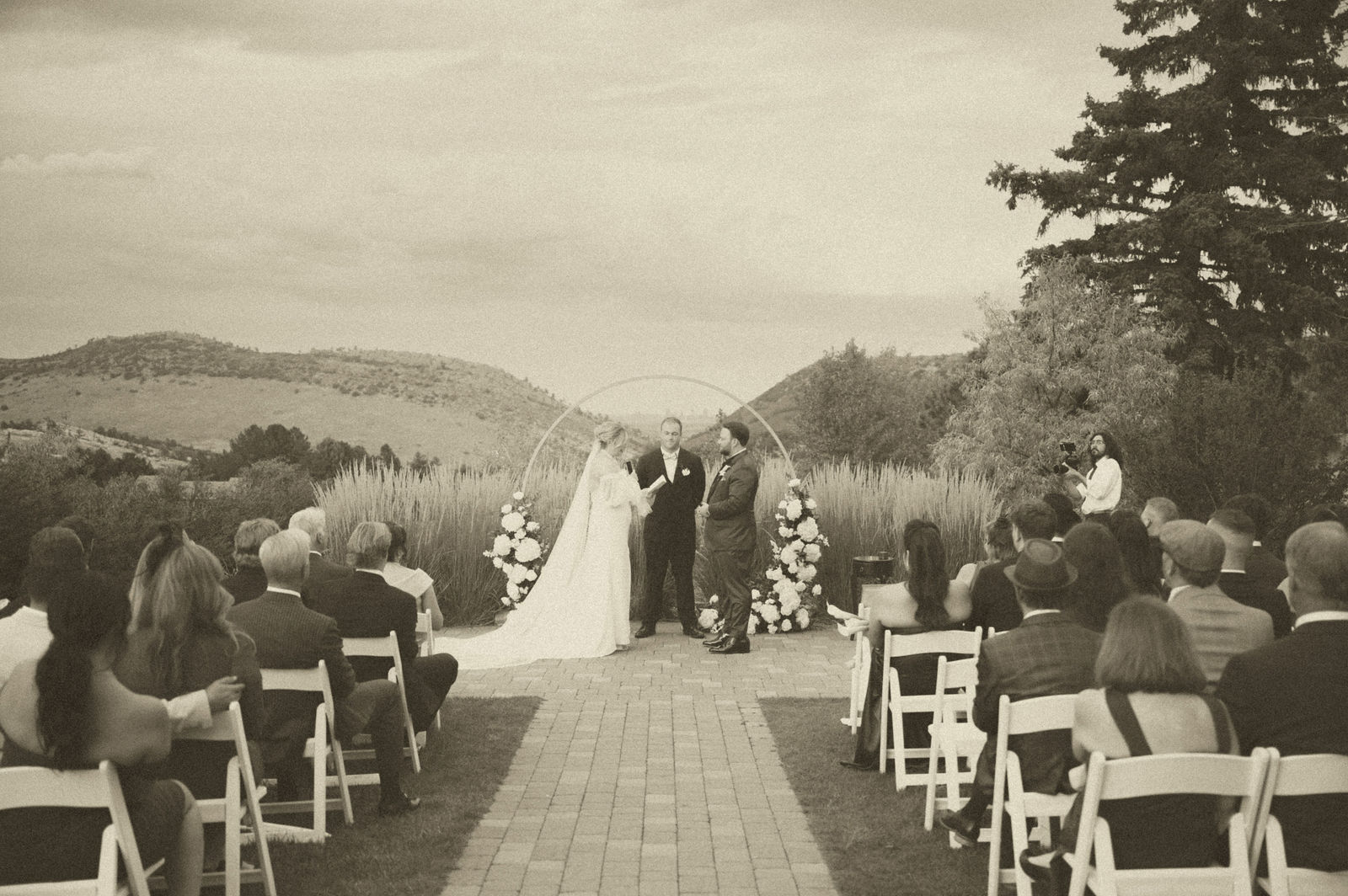 Outdoor wedding ceremony at The Manor House seen from behind the guests