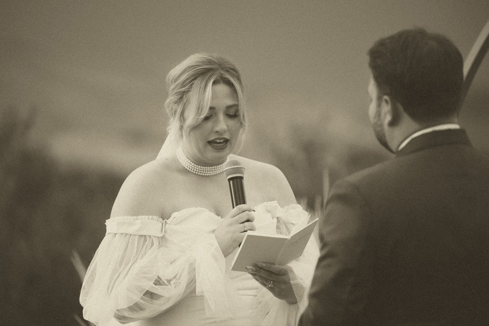 Bride laughing during her wedding vows in a vintage film edit