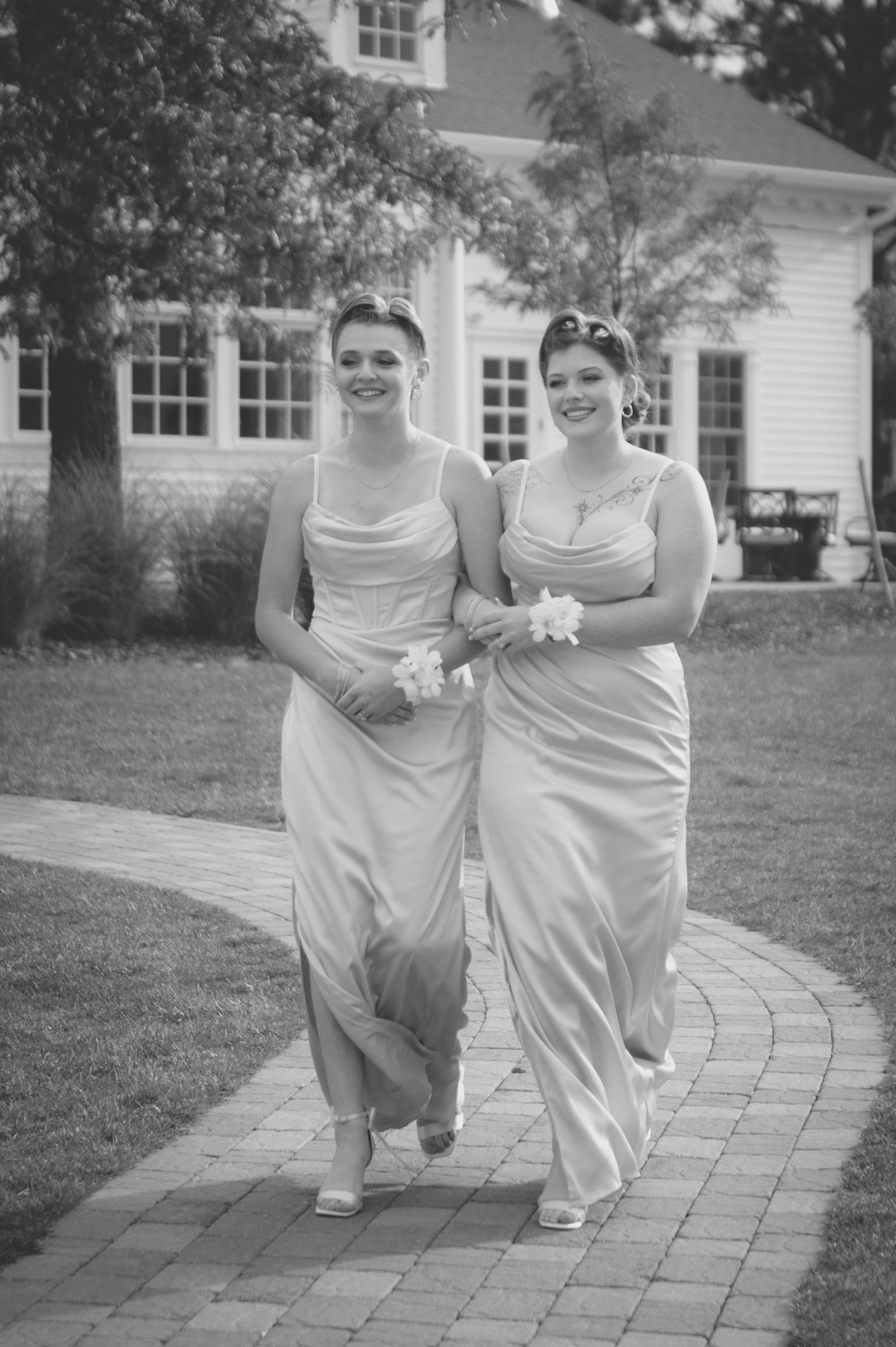 Bride walking down the outdoor aisle at The Manor House in Littleton