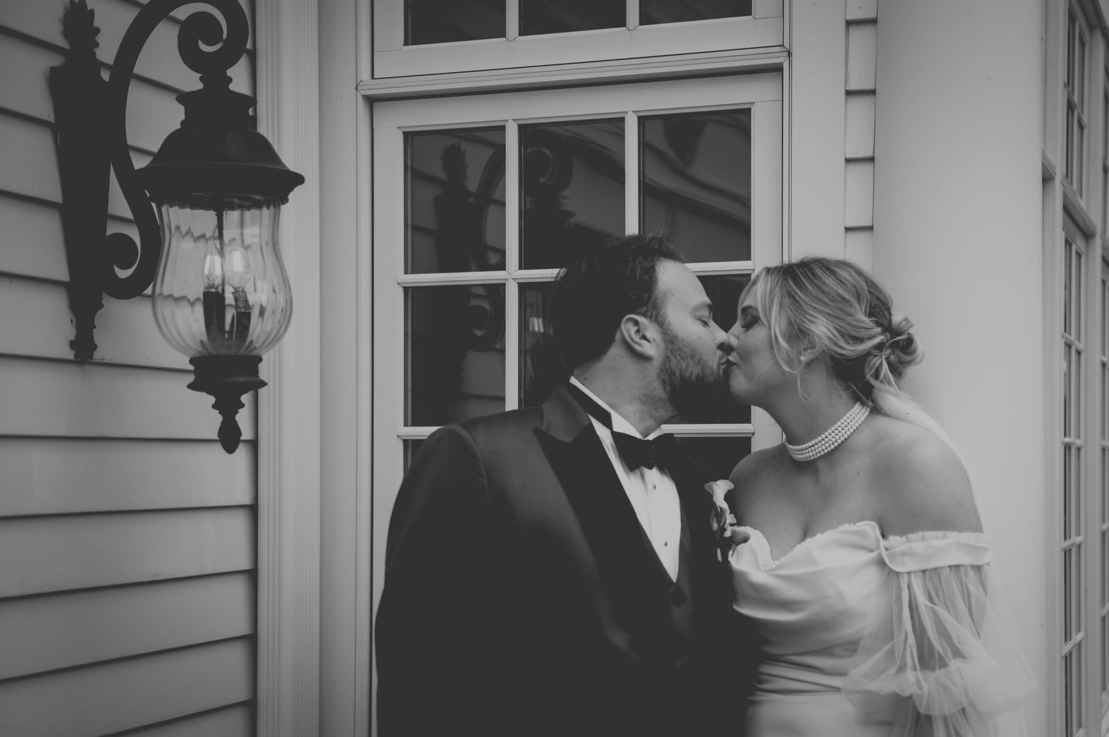 Bride and groom in the doorway of The Manor House in Littleton Colorado